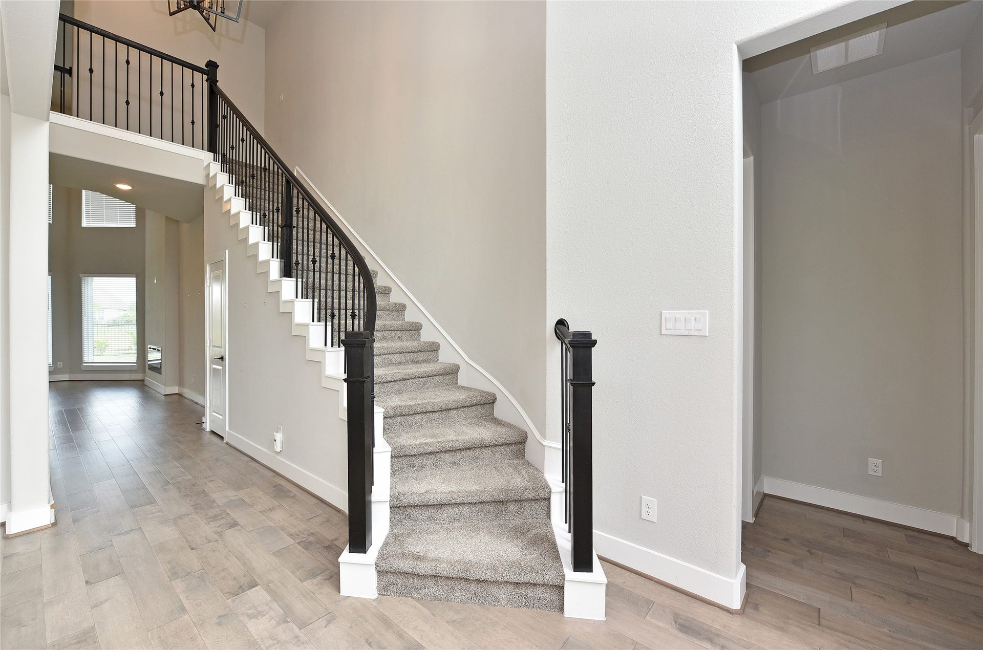 Upon entering, a sweeping staircase greets you.