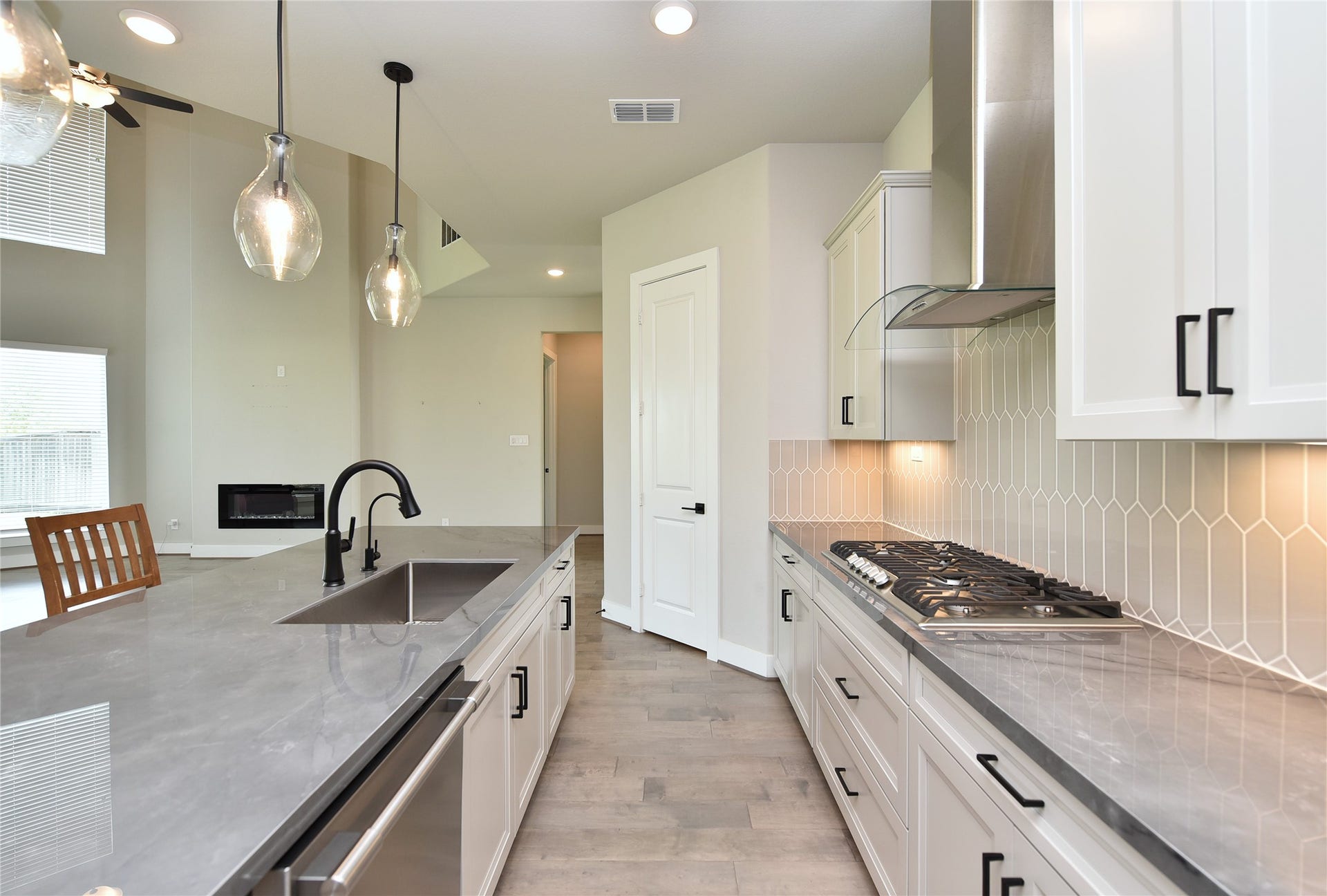 Another view of kitchen with walk in pantry in background.