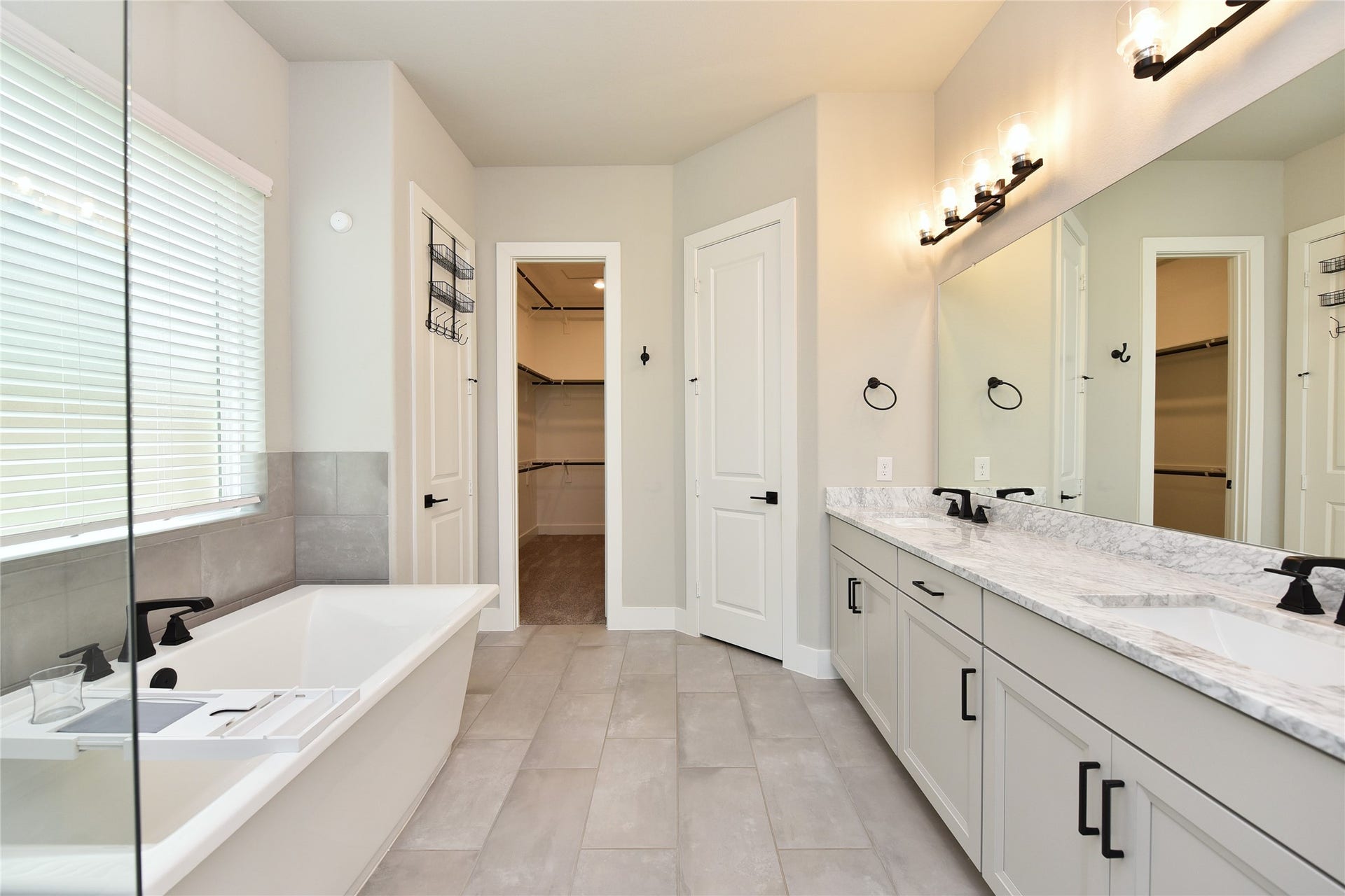 The primary bath offers step in tiled shower and soaking tub.