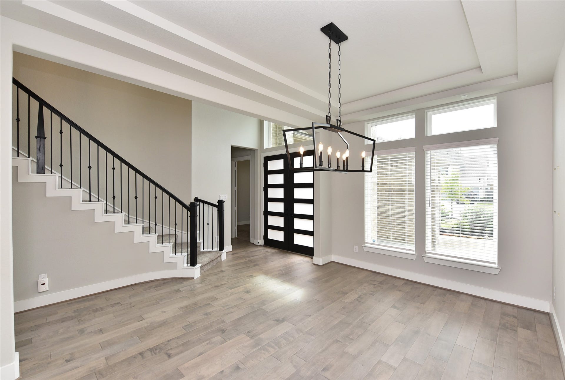 From formal dining, you can see the inviting entry and staircase.  Entrance to very private study & half bath is in background.