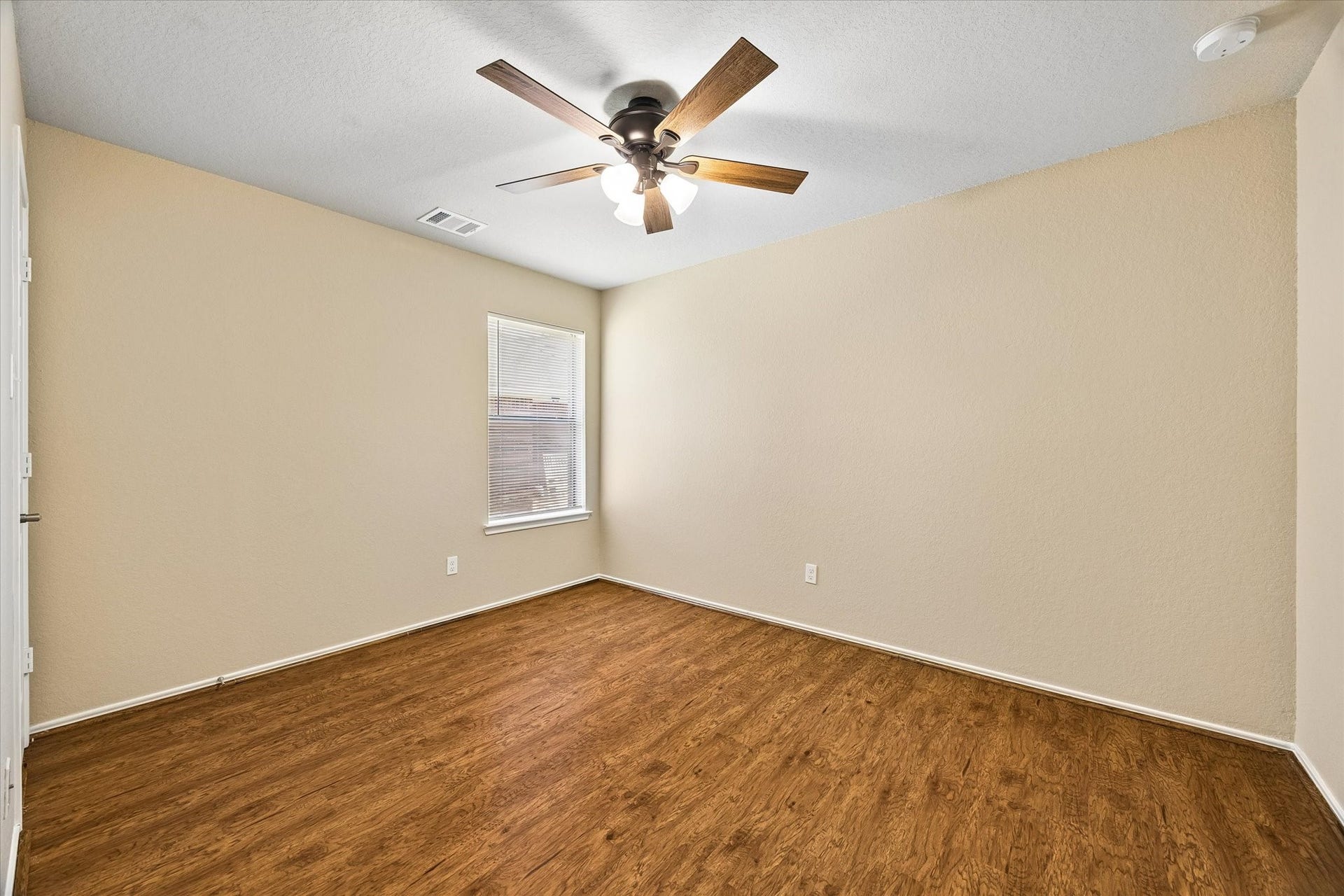 18127 Hillock Glen Lane, Cypress, TX 77429 Additional bedroom with neutral finishes, wood-look flooring, and updated ceiling fan. Flexible space for guests, hobbies, or a home office.