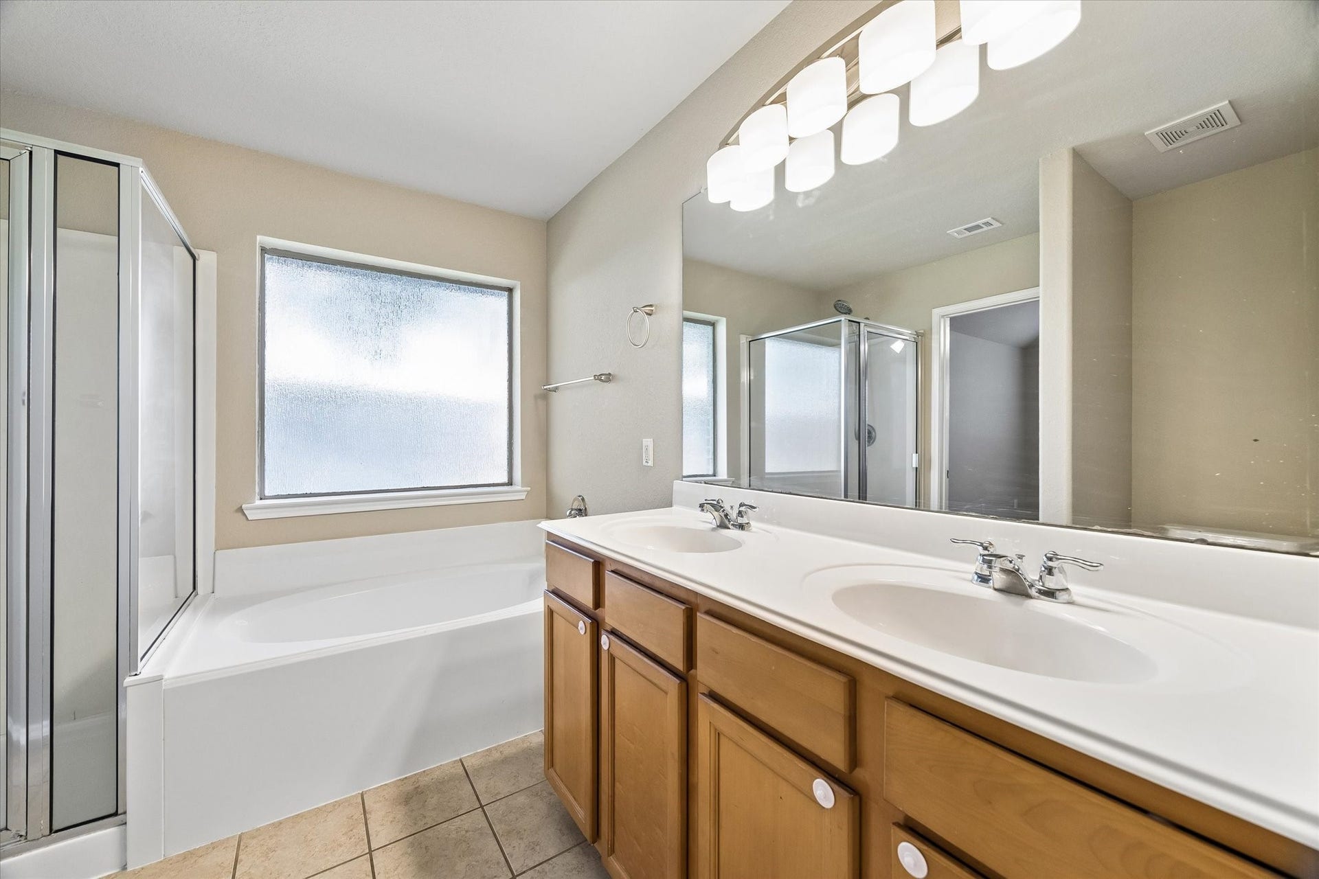 18127 Hillock Glen Lane, Cypress, TX 77429 Enjoy a separate shower, soaking tub, and dual-sink vanity in the primary bathroom.