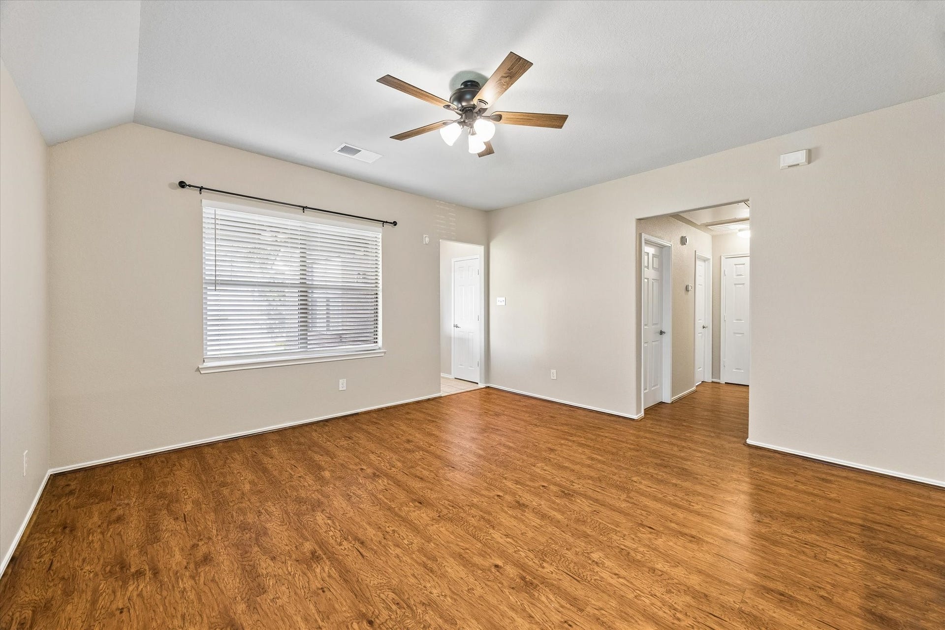 18127 Hillock Glen Lane, Cypress, TX 77429 Open floor plan create a comfortable gathering space with updated ceiling fan and neutral interior colors.