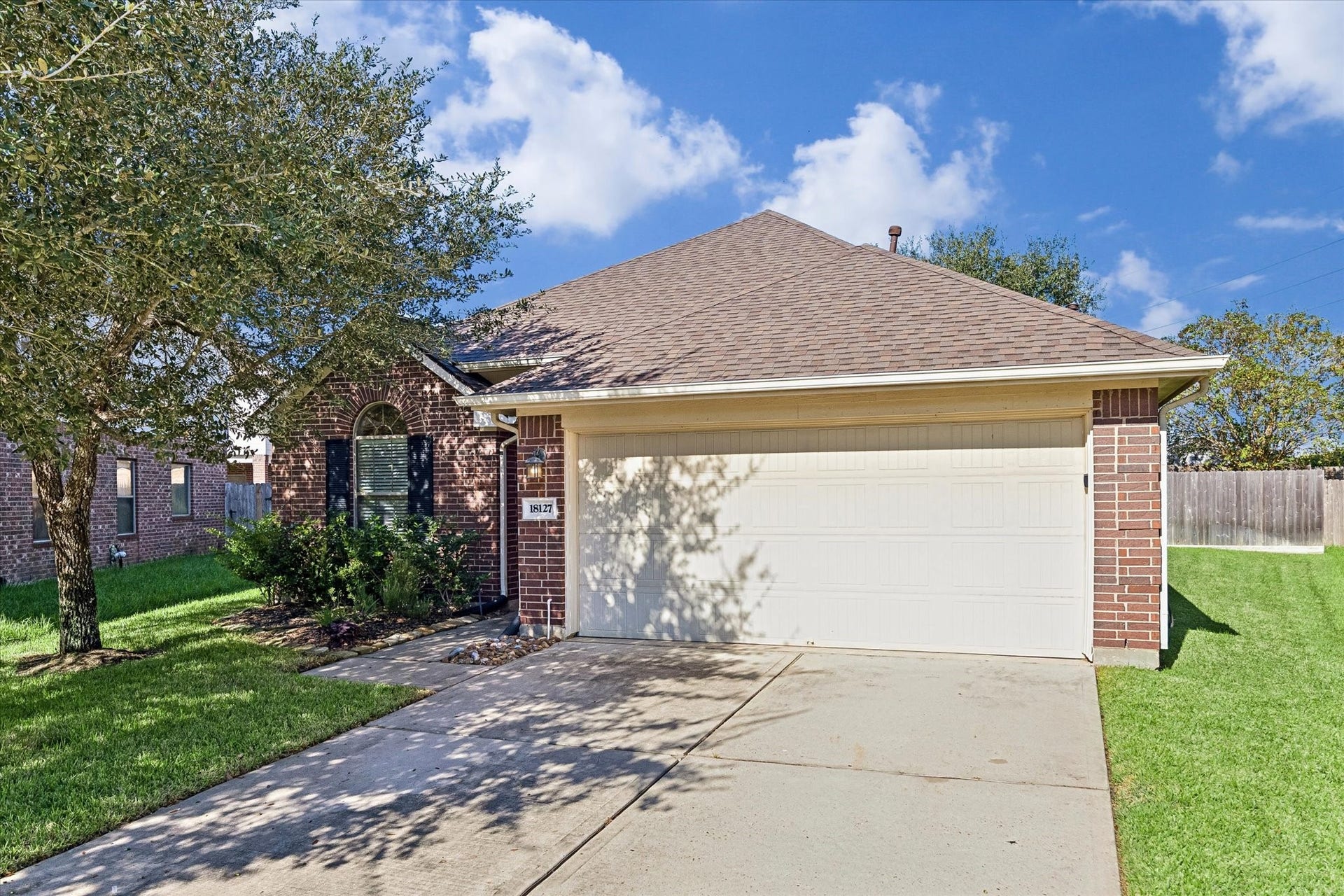 18127 Hillock Glen Lane, Cypress, TX 77429 Attractive brick exterior featuring a two-car attached garage, mature shade trees, and established landscaping. Roof replaced approximately 2 years ago!