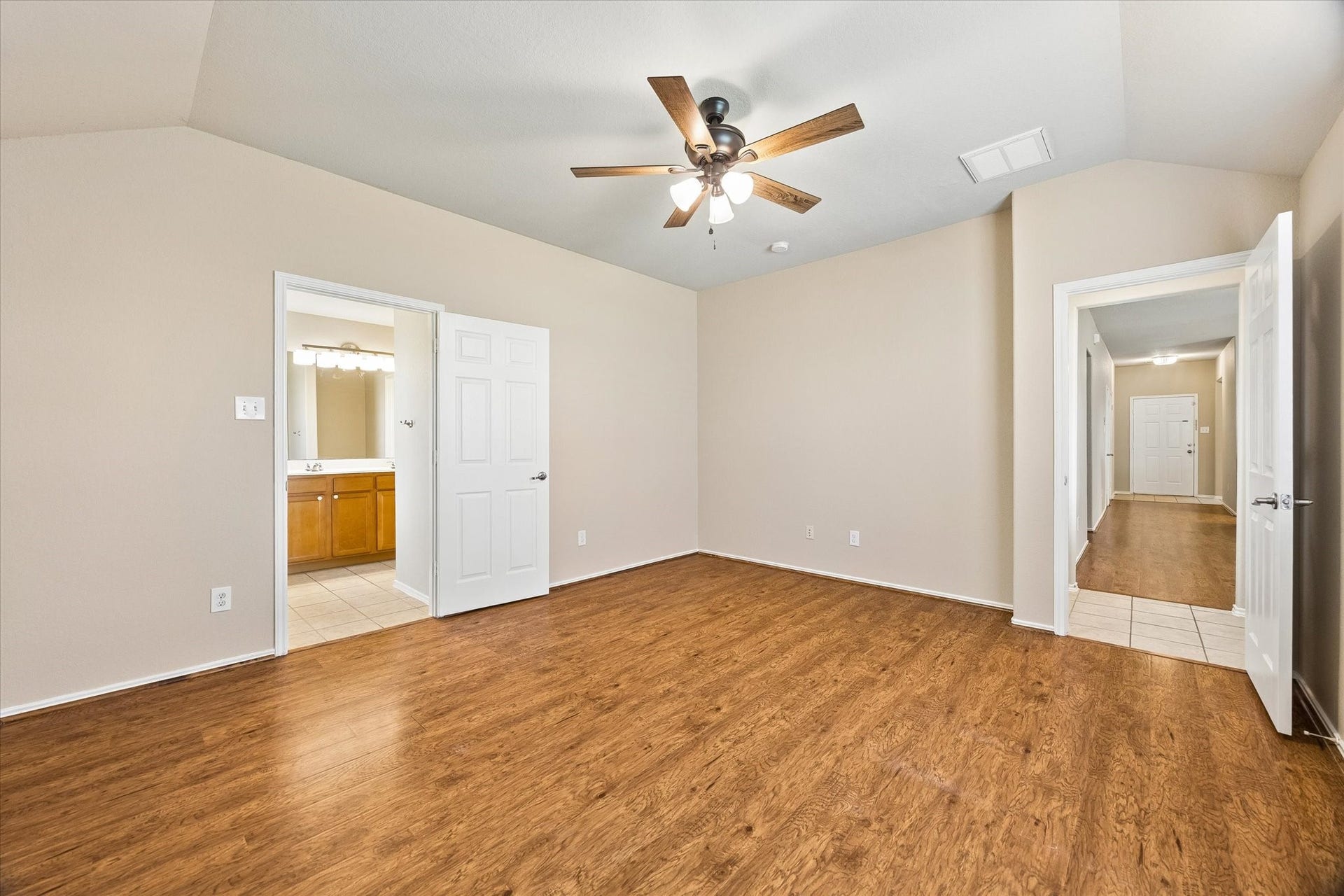 18127 Hillock Glen Lane, Cypress, TX 77429 Another view of the primary suite showcasing the comfortable layout, neutral finishes, and convenient access to the private bathroom.