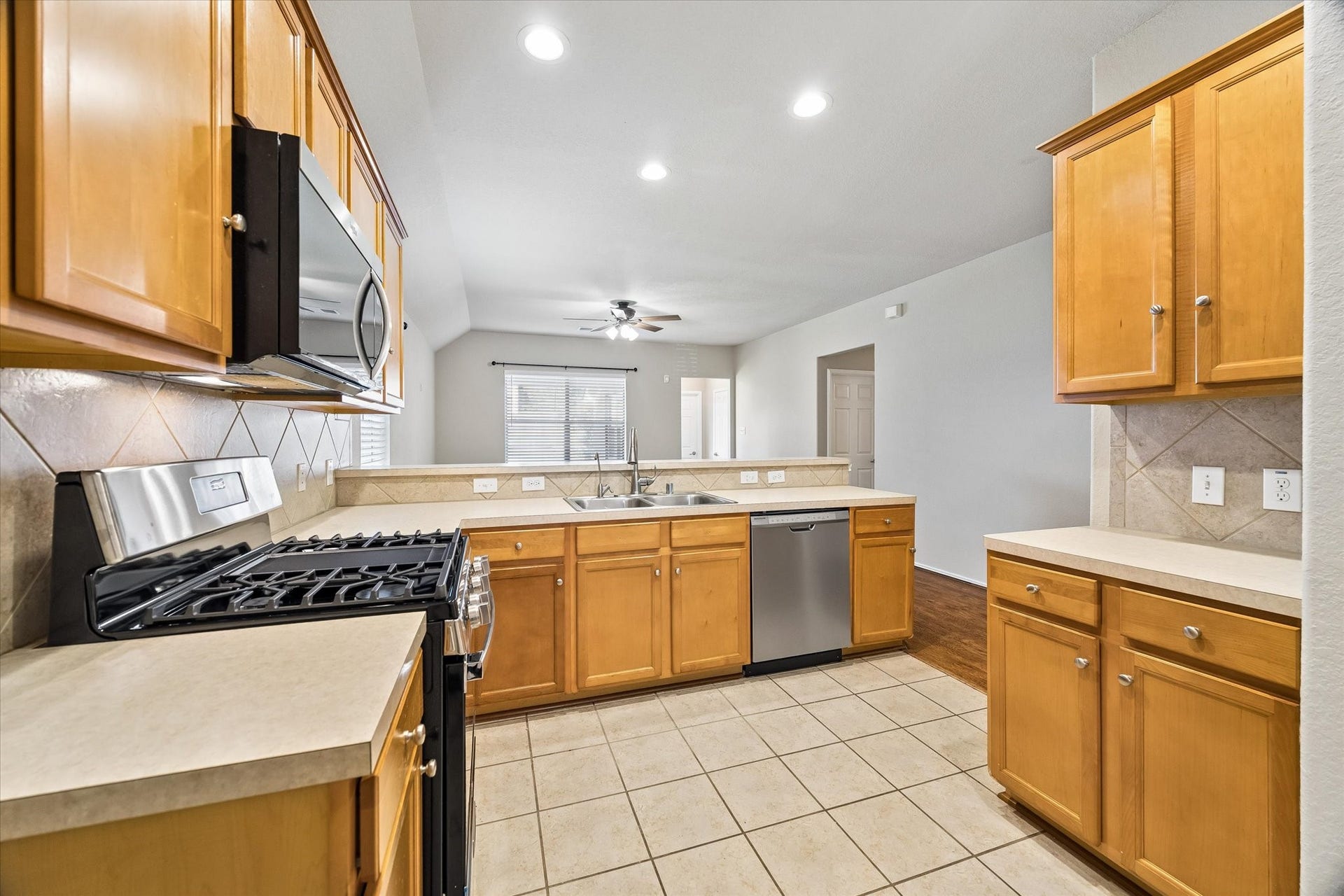 18127 Hillock Glen Lane, Cypress, TX 77429 Warm wood cabinetry, stainless steel appliances, and generous counter space make this kitchen both functional and inviting.