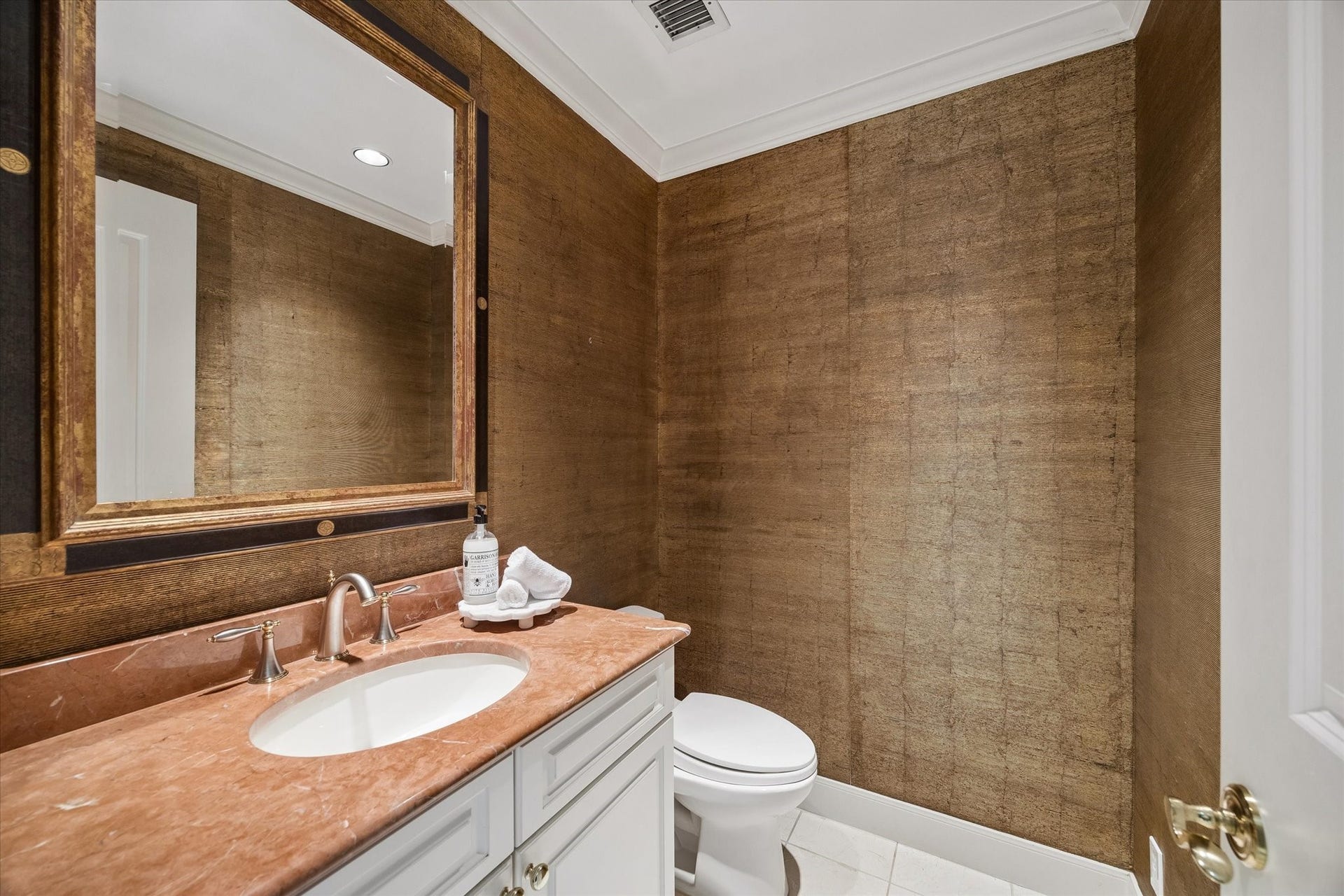 Attractive powder bath off formal entry.