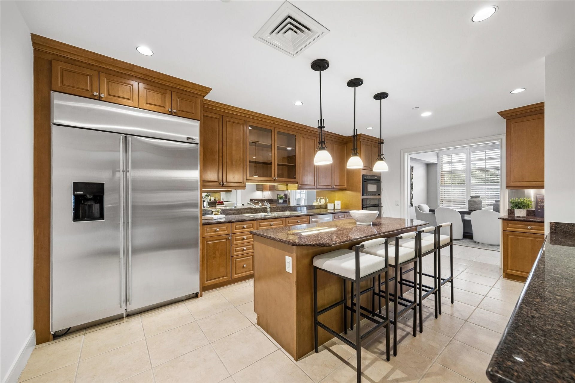 Island kitchen with breakfast bar.  Lots of counter and cabinet space. Looking towards dining room.