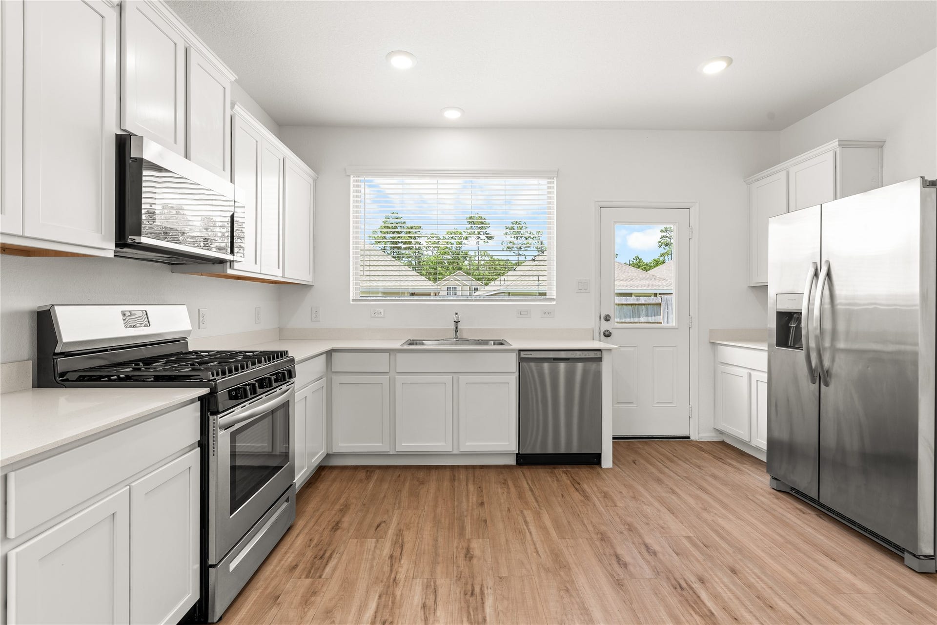 1938 Foxtail Creek Ct, Crosby, TX 77532 The thoughtfully designed kitchen offers abundant cabinetry, generous counter space, stainless steel appliances, and an open layout that keeps you connected to the main living areas and easy access to the backyard.