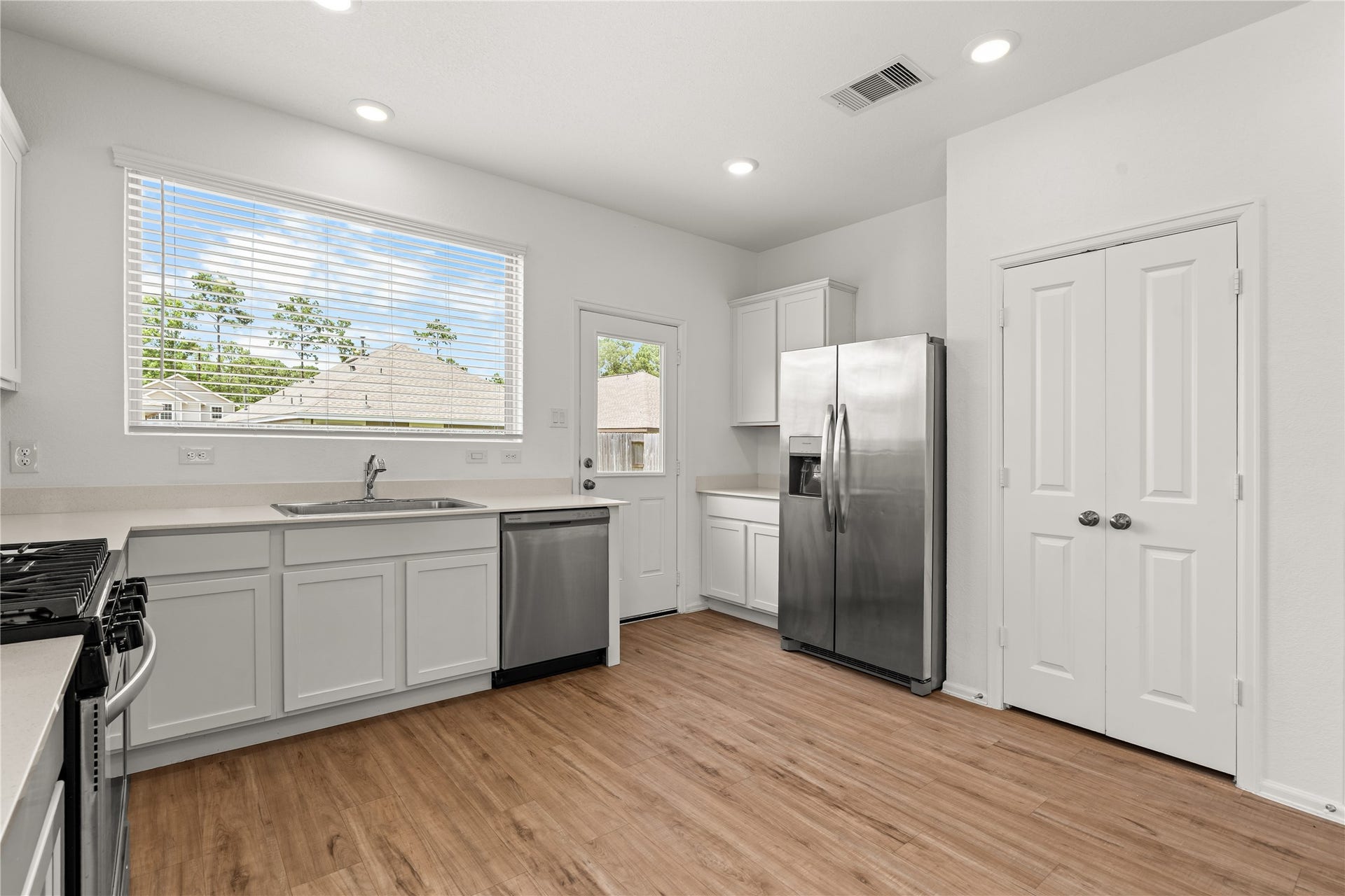 1938 Foxtail Creek Ct, Crosby, TX 77532 Natural light fills this bright and functional kitchen, where abundant cabinetry, generous counter space, and stainless steel appliances create a space designed for everyday living.