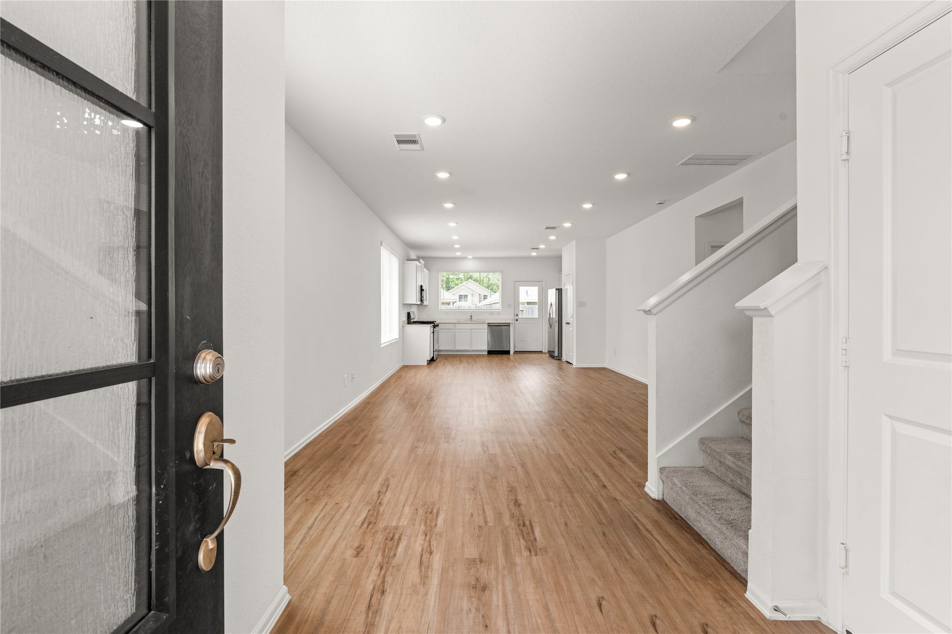 1938 Foxtail Creek Ct, Crosby, TX 77532 The inviting entry opens to a spacious, open concept design where the living, dining, and kitchen areas come together seamlessly, creating a comfortable space to gather, entertain, and make lasting memories.