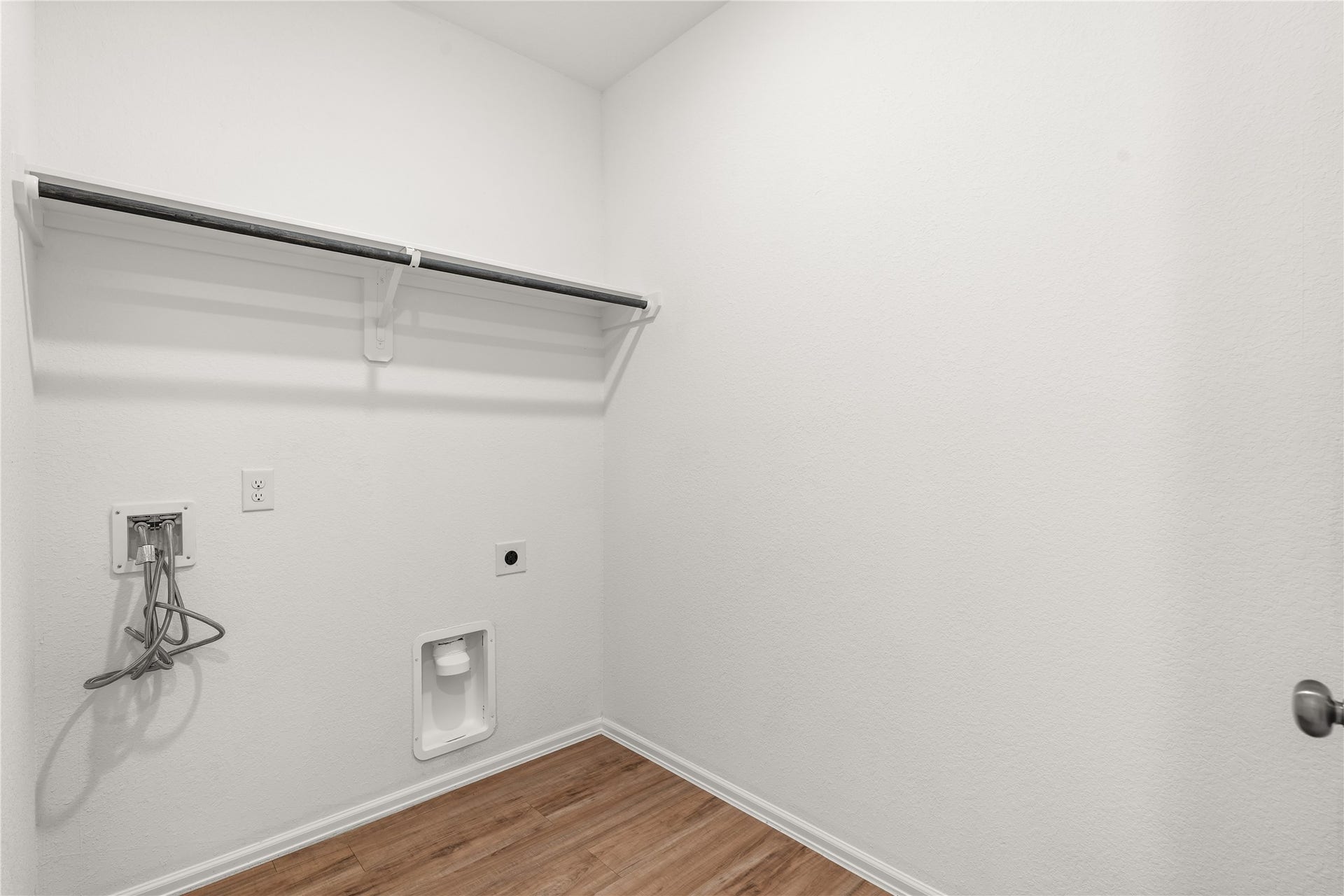 1938 Foxtail Creek Ct, Crosby, TX 77532 Laundry room with built in shelving, hanging space, and room for a full size washer and dryer.