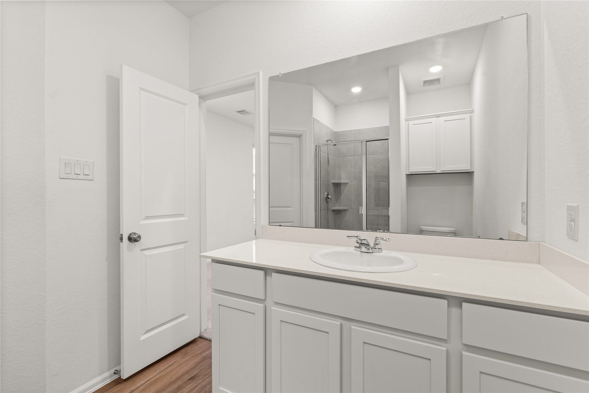 1938 Foxtail Creek Ct, Crosby, TX 77532 The private primary bath combines generous counter space, abundant storage, and a walk in shower for a functional and inviting owner's retreat.