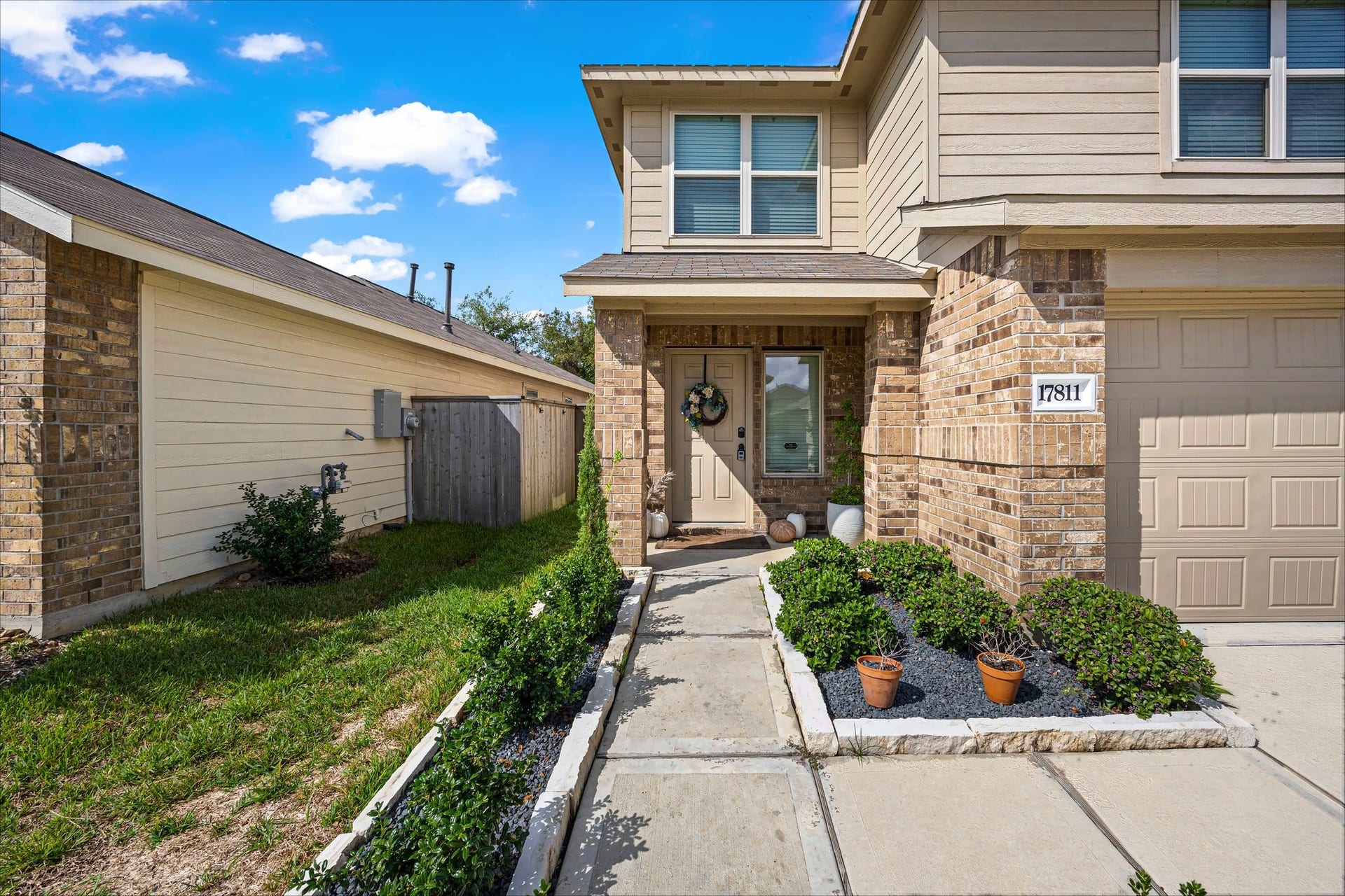 17811 Pemswood Drive, Hockley, TX 77447 Covered front entry with brick surround and a landscaped walkway