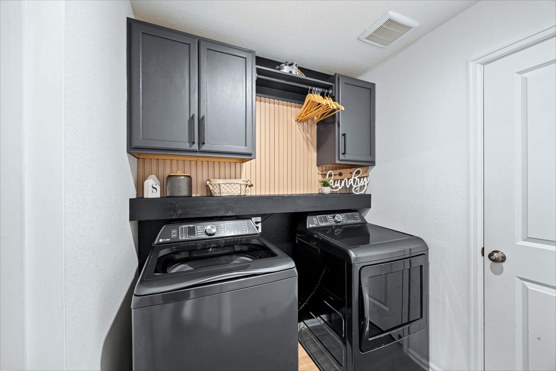 17811 Pemswood Drive, Hockley, TX 77447 Laundry room with built-in cabinets and a hanging rod