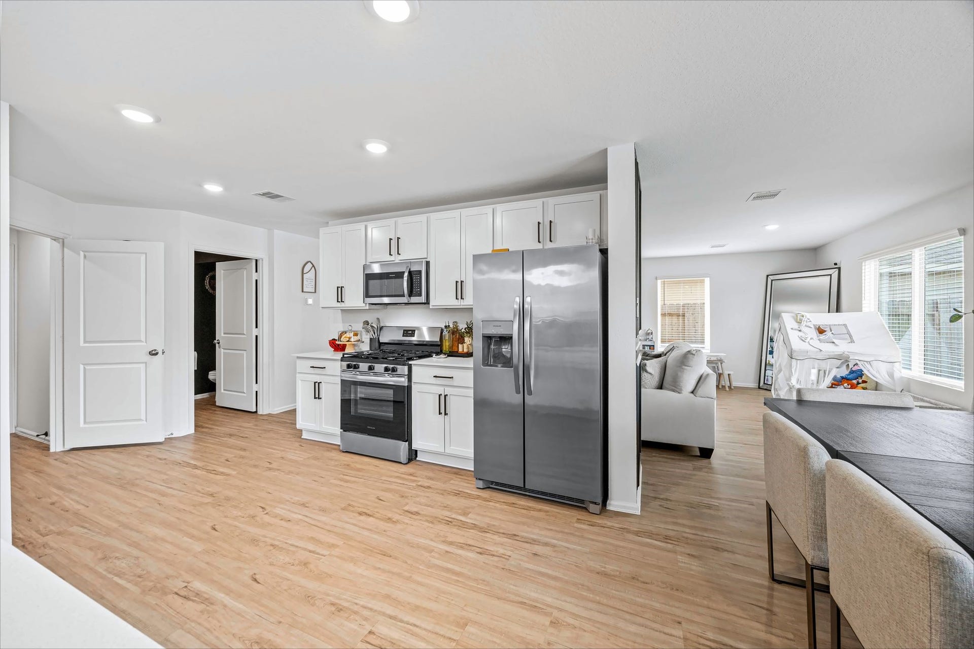 17811 Pemswood Drive, Hockley, TX 77447 Kitchen with white cabinets, stainless appliances and an open layout