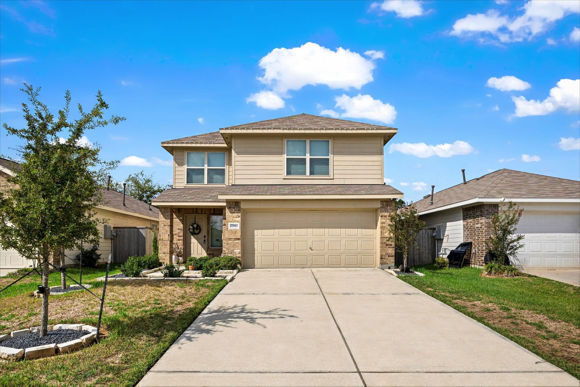 17811 Pemswood Drive, Hockley, TX 77447 Two-story home with brick and siding accents and an attached 2-car garage