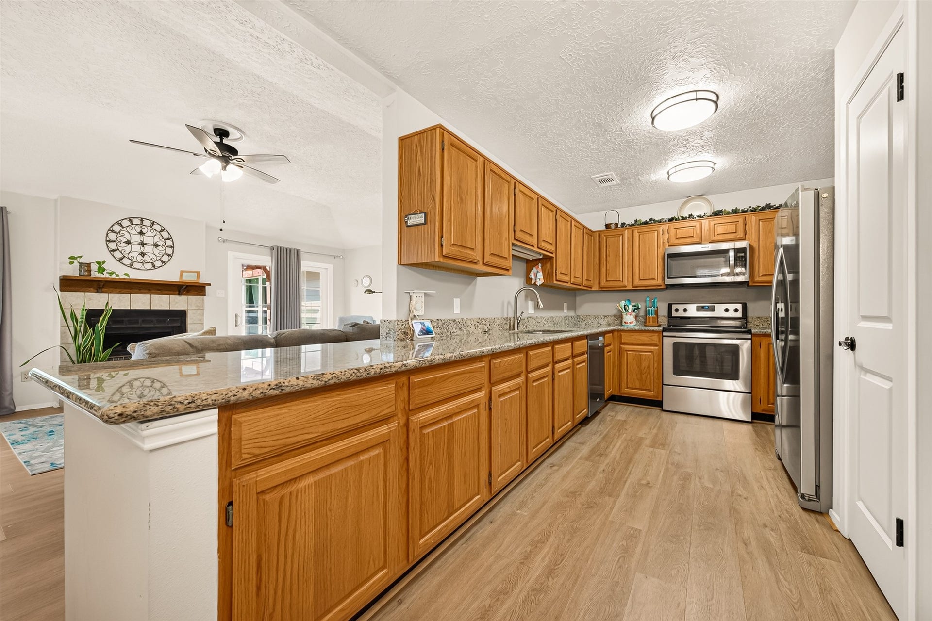 2123 Collingsfield Drive, Sugar Land, TX 77478 Spacious kitchen with granite countertops, stainless steel appliances, and warm wood cabinetry