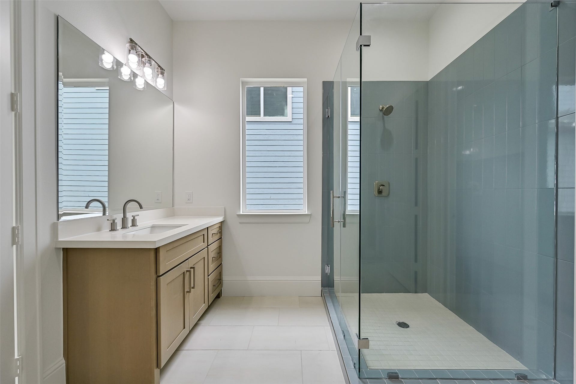 1627 Bay Pointe Drive, Galveston, TX 77554 Gorgeous blue tile surrounds the shower, adding a beautiful pop of color and coastal charm to the space.
