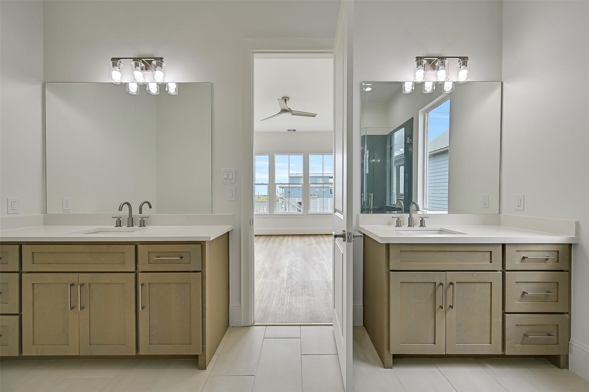 1627 Bay Pointe Drive, Galveston, TX 77554 The primary bathroom features dual vanities and a spacious walk-in shower.