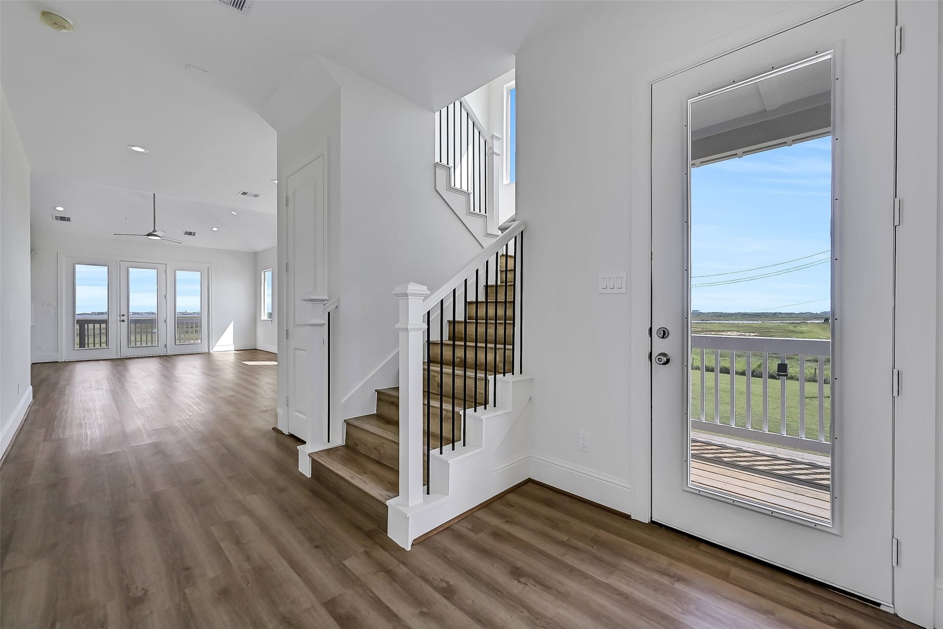 1627 Bay Pointe Drive, Galveston, TX 77554 Soaring ceilings, walls of windows that fill the home with natural light, and beautiful vinyl plank flooring can be found throughout.