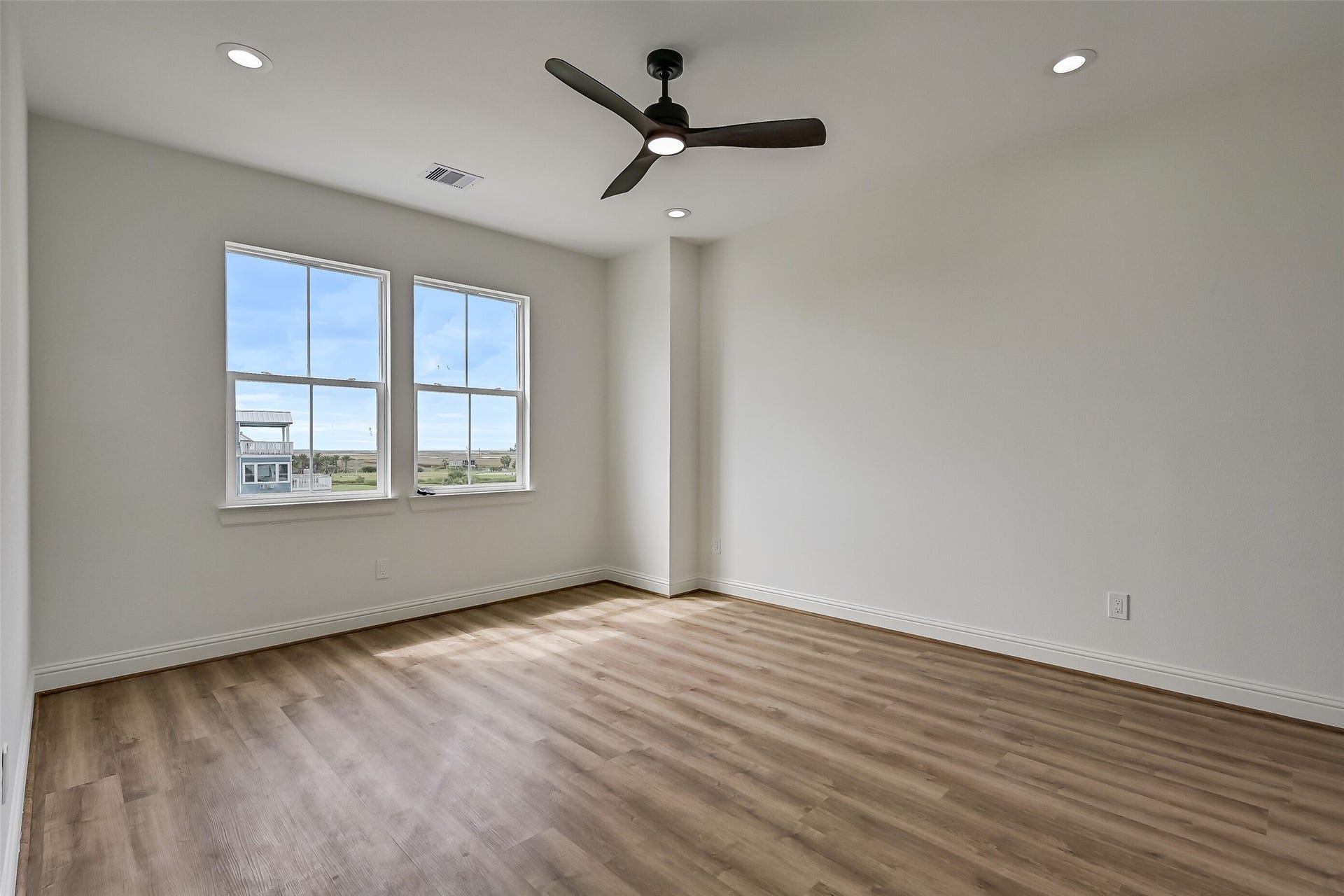 1627 Bay Pointe Drive, Galveston, TX 77554 The first of two bedrooms on the upper level is this spacious guest bedroom, offering a comfortable and inviting retreat for family or visitors.