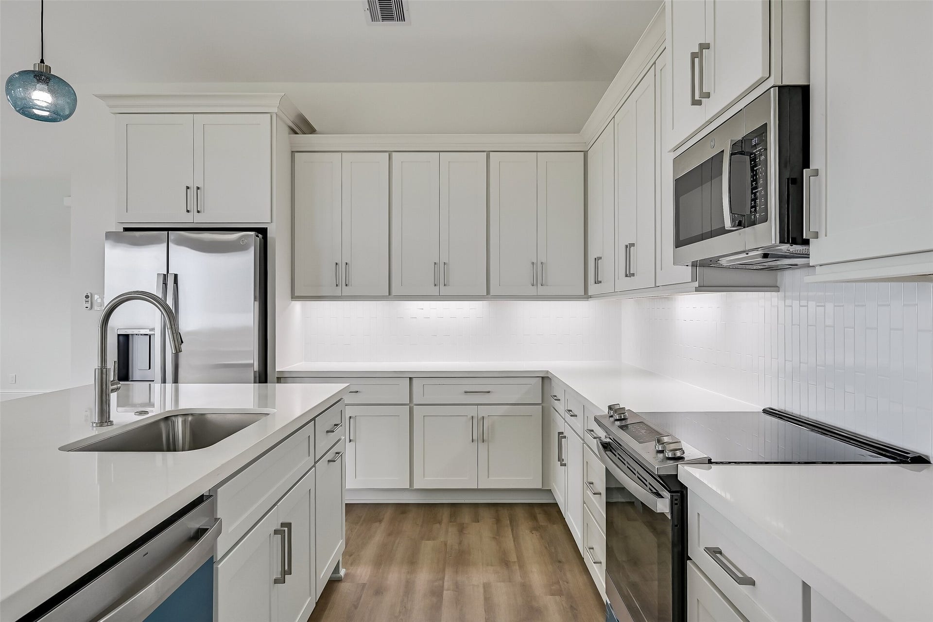 1627 Bay Pointe Drive, Galveston, TX 77554 The kitchen is thoughtfully equipped with soft-close cabinets and drawers, along with under-cabinet lighting that adds both functionality and a touch of elegance to the space.