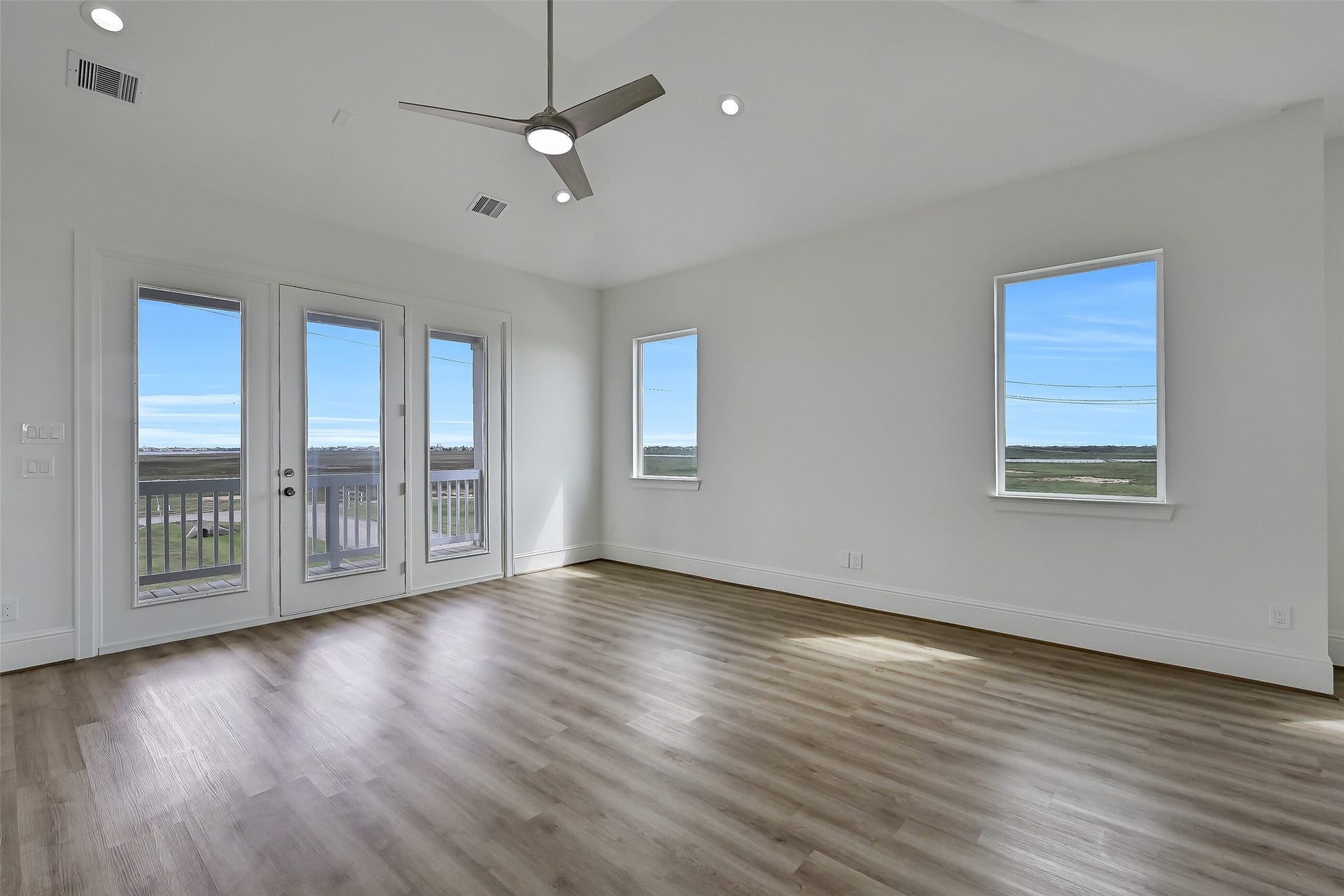 1627 Bay Pointe Drive, Galveston, TX 77554 The spacious living area. An east facing deck is found through the doors ahead.