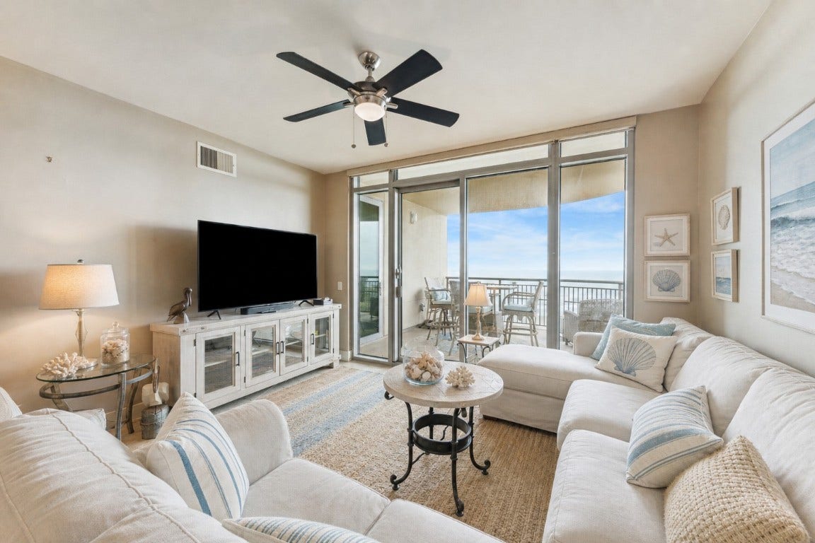 801 E Beach Drive, #TW0908, Galveston, TX 77550 Elegant neutral tile flooring seamlessly extends throughout the space, while expansive floor-to-ceiling windows and doors invite abundant natural light and offer breathtaking views.(AI furniture)