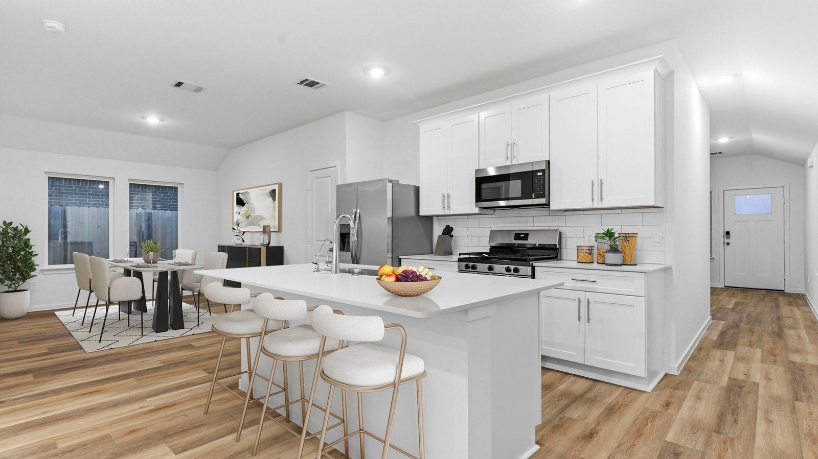 3510 Wild Mustang Street, League City, TX 77511 Bright and spacious kitchen with quartz countertops, stainless steel appliances, and an island with bar seating
