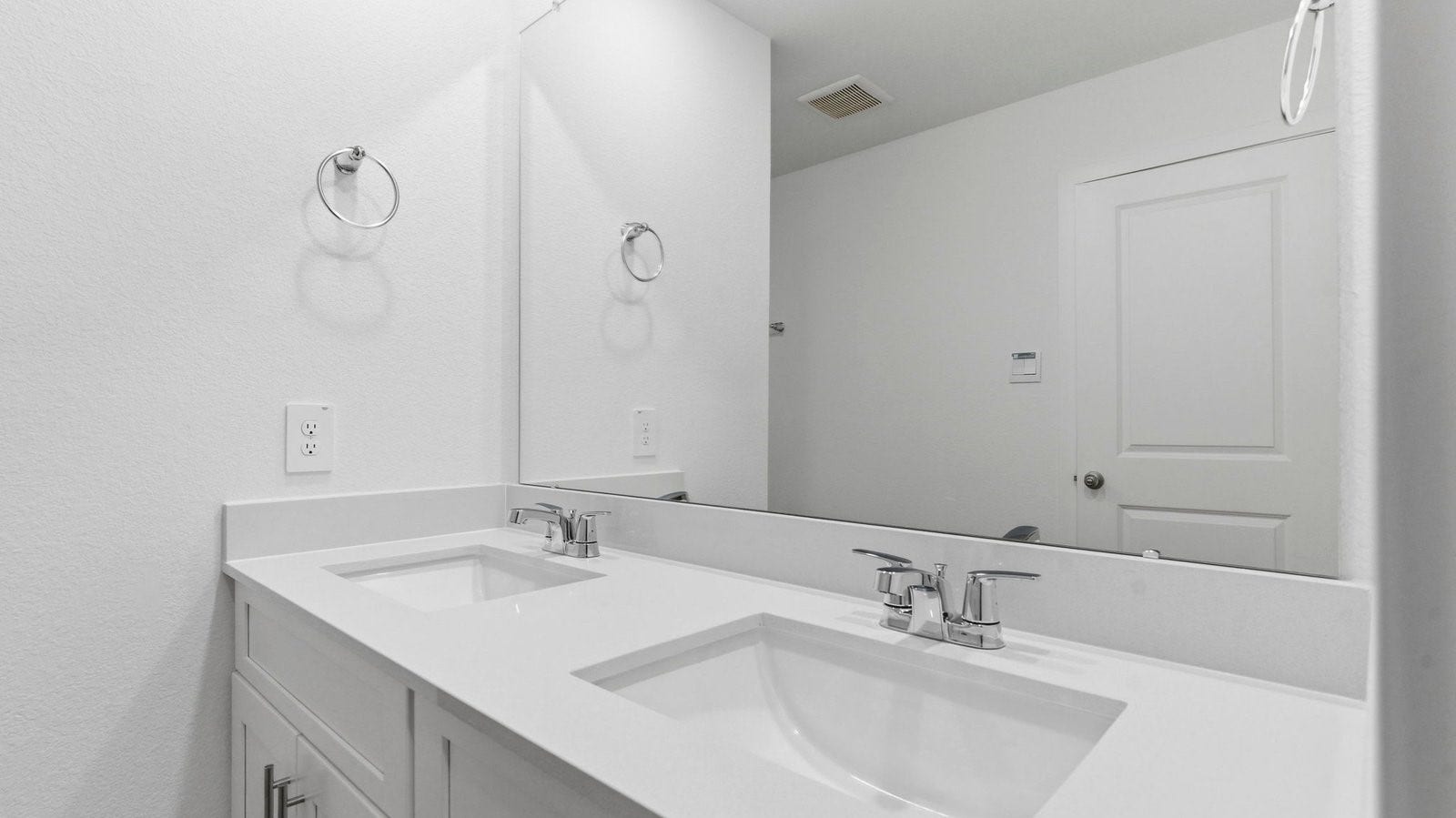 3510 Wild Mustang Street, League City, TX 77511 Modern primary bathroom with double vanities, quartz countertops, and a glass-enclosed shower with a walk-in closet.