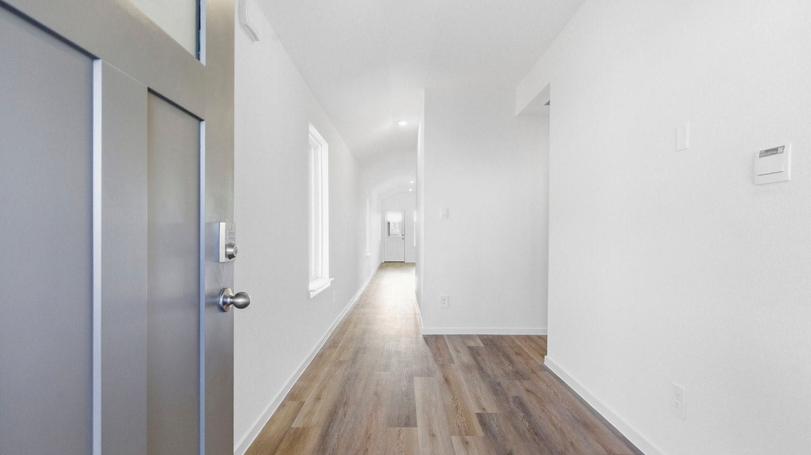 3510 Wild Mustang Street, League City, TX 77511 Entry hallway leading to living room and kitchen in the background.