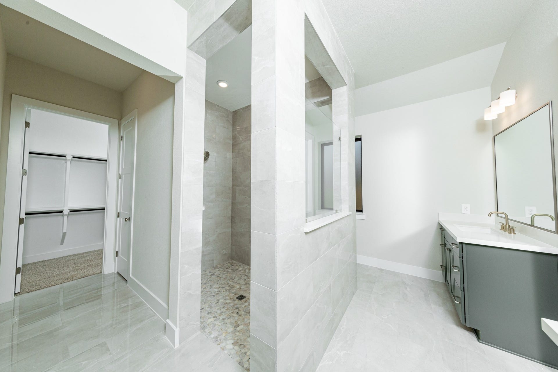 1915 Langford Street, Montgomery, TX 77316 The walk-in shower boats of stylish tile surround and a pebble mosaic tile flooring.