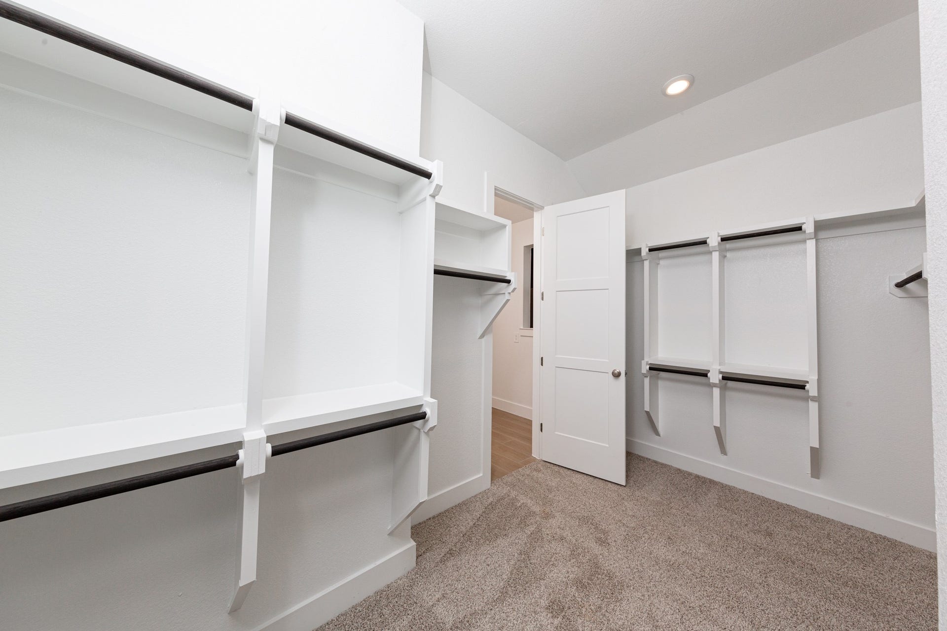 1915 Langford Street, Montgomery, TX 77316 Look at this immaculate closet! With high shelving, multiple rows to hang clothing, you are sure to have enough room for all your belongings! The primary closet has access to the laundry room for convience!