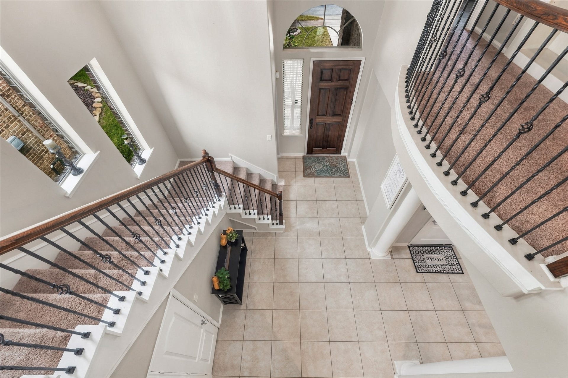 20815 S Blue Hyacinth Drive, Cypress, TX 77433 Look up! The sweeping staircase, wrought-iron railing, arched openings, and open second-floor landing give the entry plenty of architectural personality.