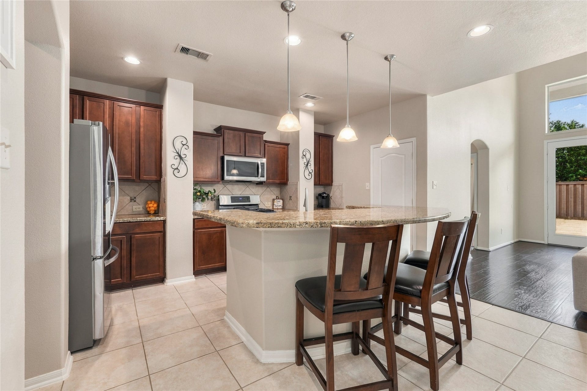 20815 S Blue Hyacinth Drive, Cypress, TX 77433 The kitchen sits right in the heart of the home with rich cabinetry, granite countertops, stainless appliances, and a large island that naturally becomes a gathering spot.