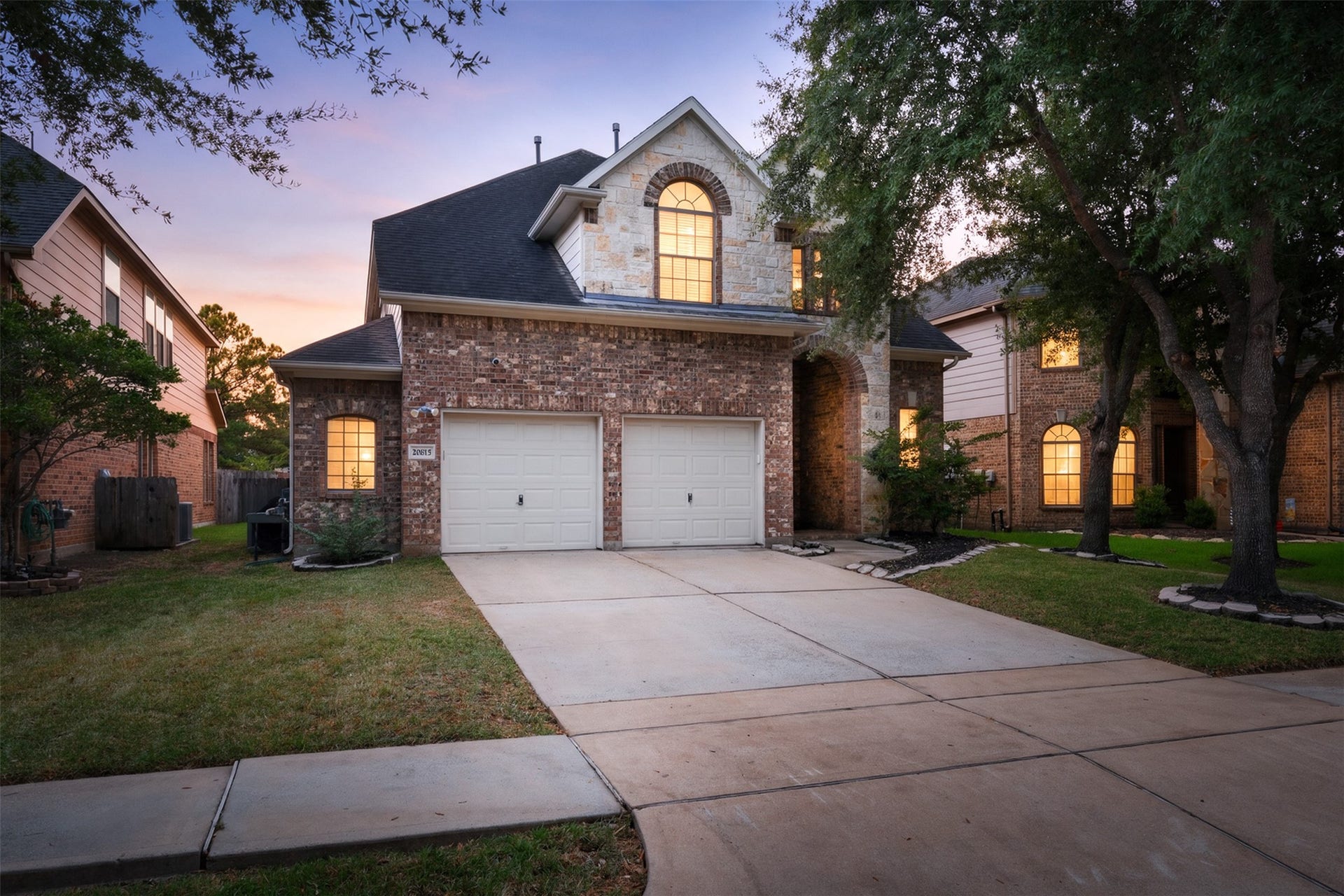 20815 S Blue Hyacinth Drive, Cypress, TX 77433 A beautiful first impression framed by mature trees, with brick and stone details giving this two-story home a warm, established look.