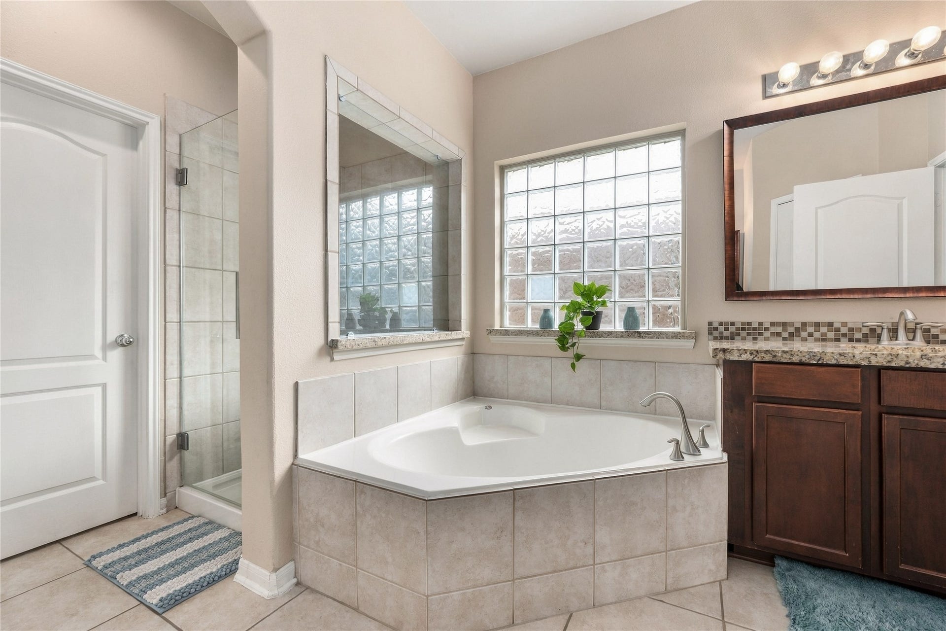 20815 S Blue Hyacinth Drive, Cypress, TX 77433 The soaking tub creates a relaxing centerpiece in the primary bath, with a separate shower nearby for the best of both worlds.