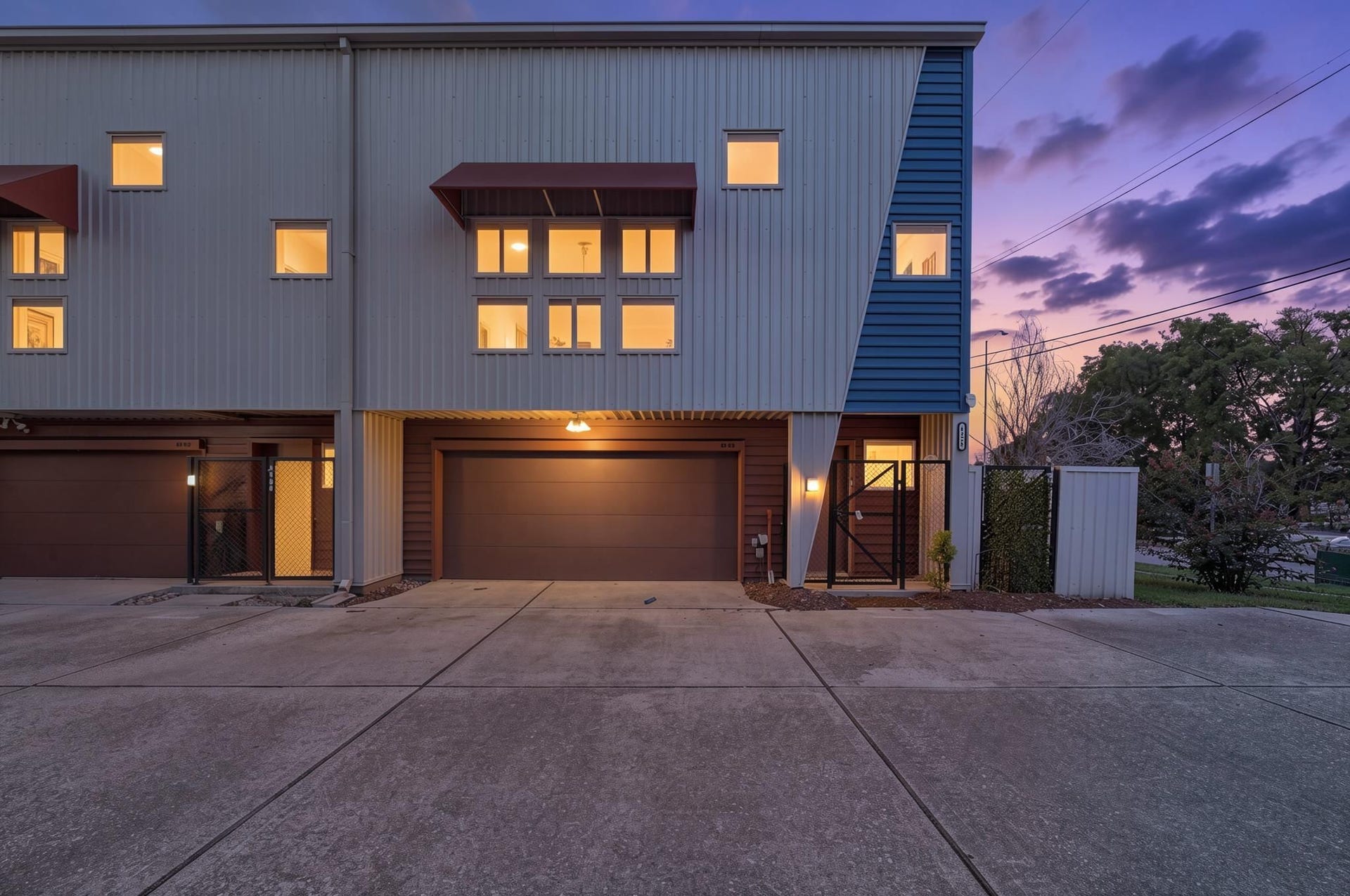 6128 Grand Boulevard, Houston, TX 77021 The exterior introduces a modern three-story corner-unit townhome in the Hermann Park District with clean lines, warm evening light, and attached garage access. The corner placement gives the home added presence and natural light from multiple sides