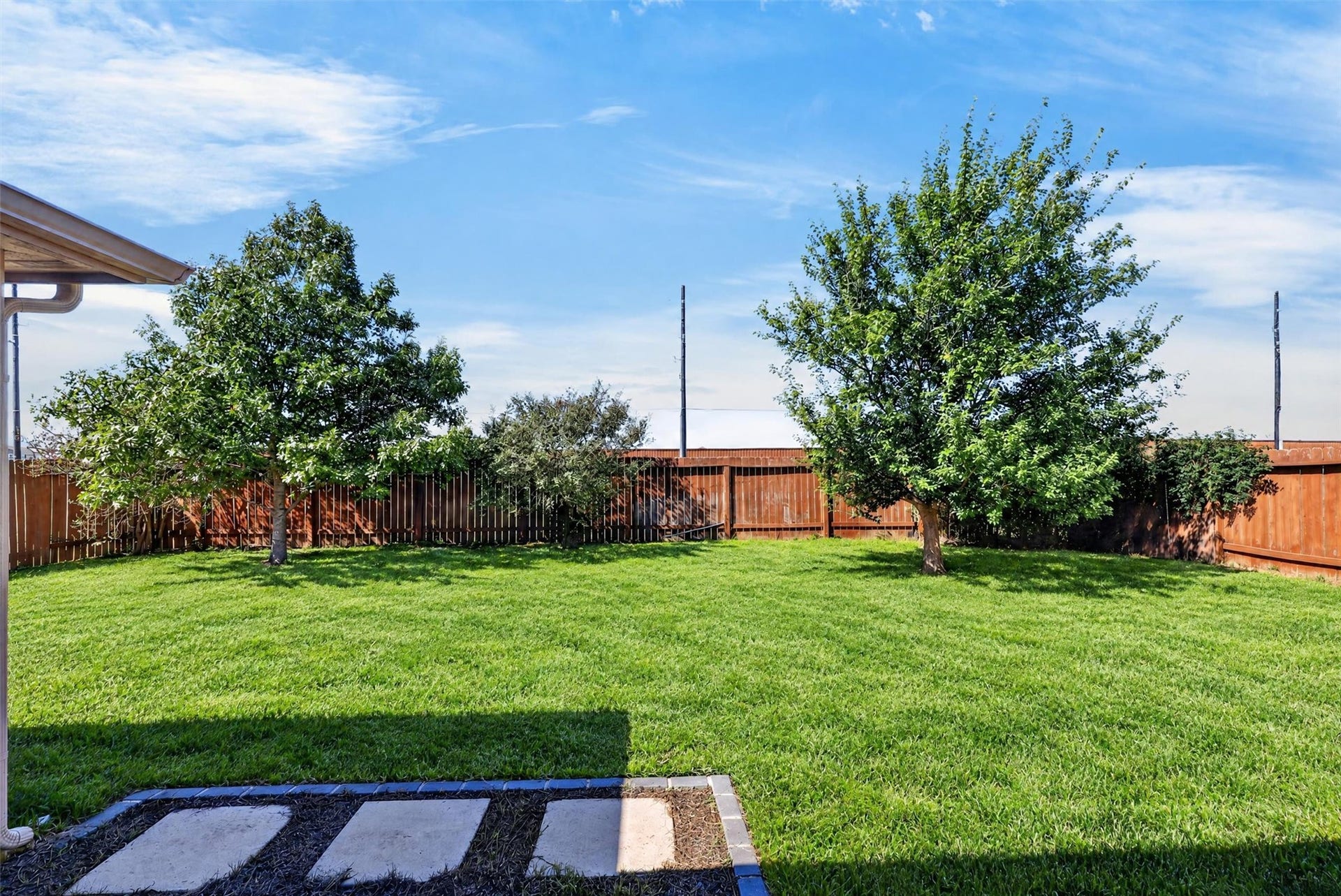 22907 Gentle Shadow Drive, Hockley, TX 77447 Mature trees frame the spacious, fenced backyard, while the covered patio offers a comfortable setting for morning coffee, evening conversations, or a weekend cookout.