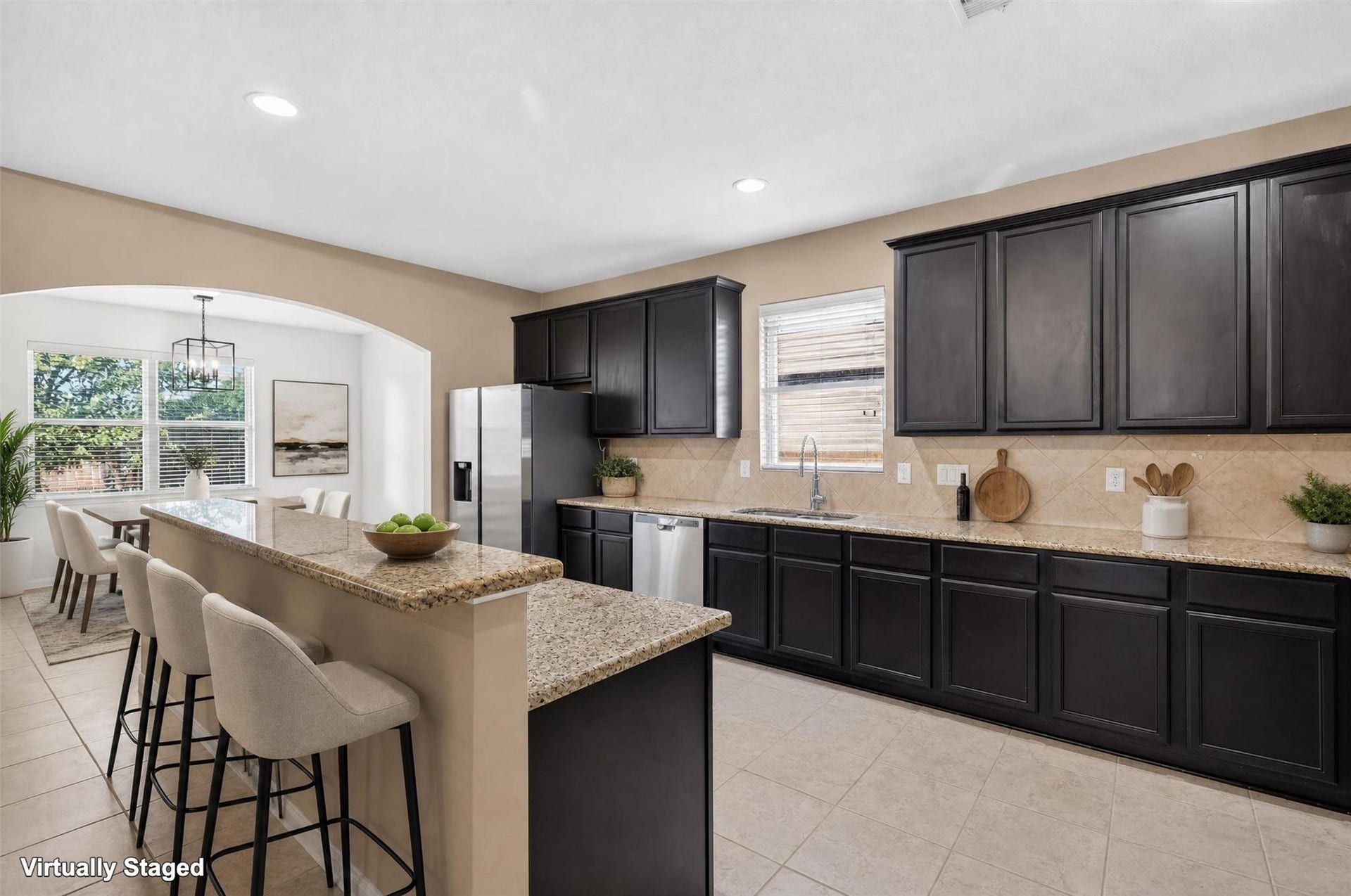 22907 Gentle Shadow Drive, Hockley, TX 77447 Natural light and inviting finishes make this kitchen a welcoming hub of the home! A window above the sink brightens the workspace