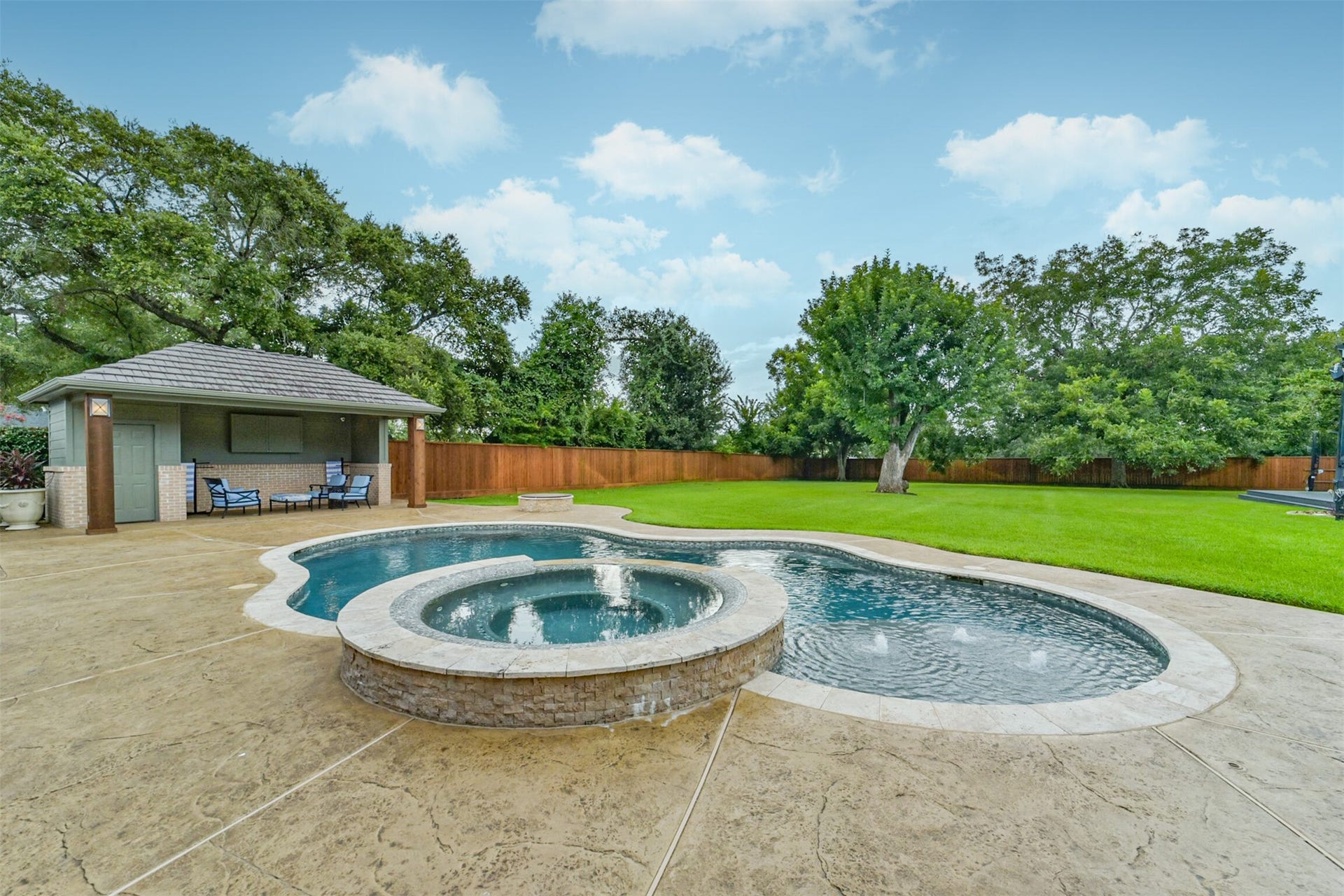 3210 Nottingham Street, Pearland, TX 77581 Pool/Spa are surrounded by stained concrete. Private and perfect on a summer day!