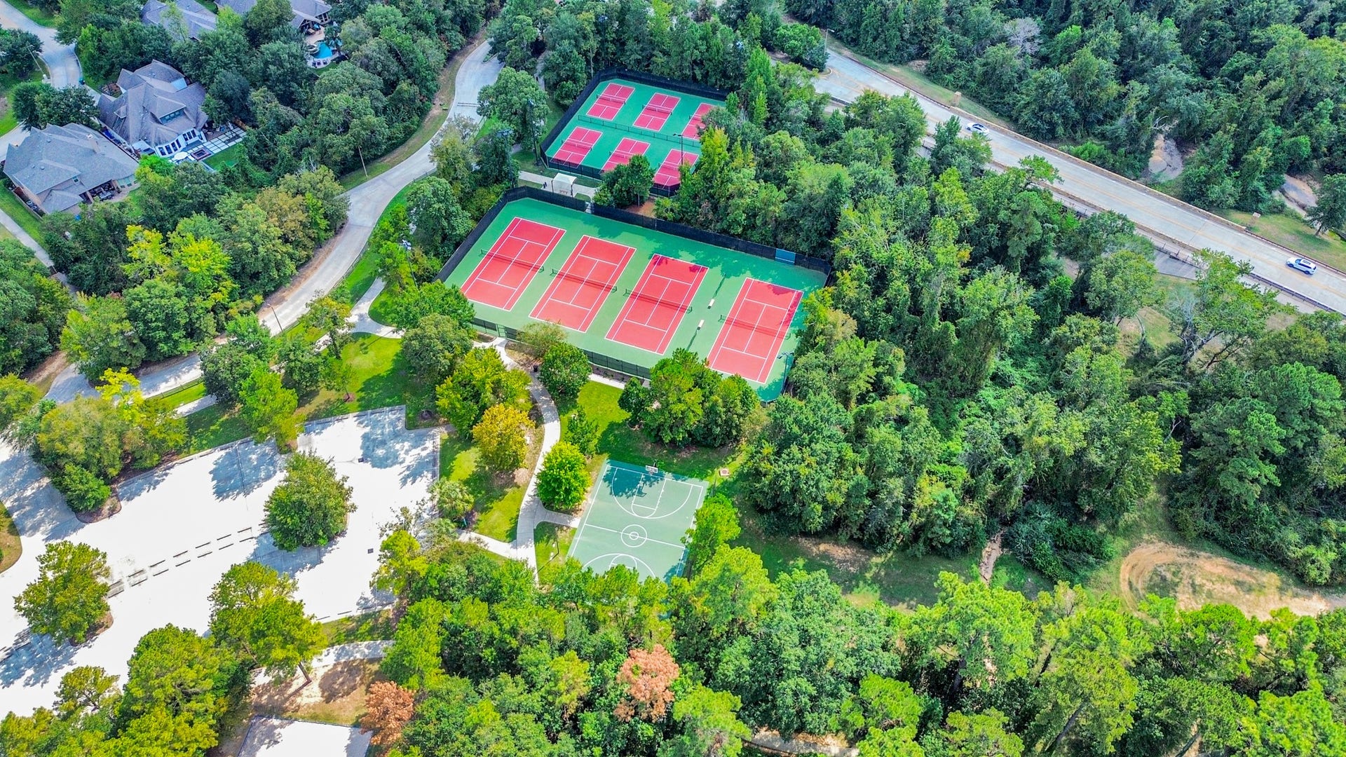 143 Pronghorn Place, Montgomery, TX 77316 Surrounded by lush greenery, this property boasts easy access to a vibrant sports complex featuring multiple tennis courts and a basketball court, ideal for active lifestyles.