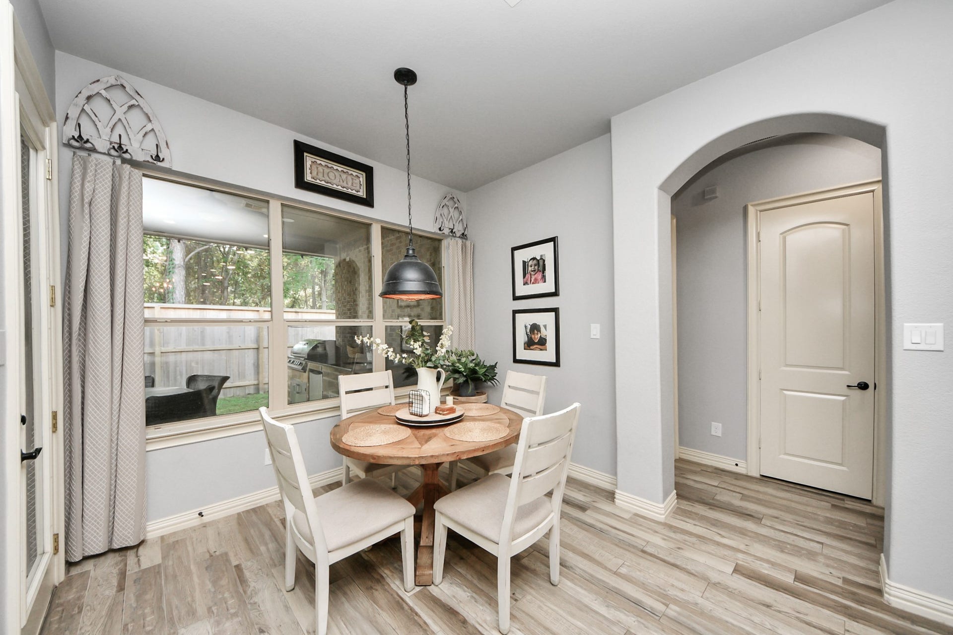 143 Pronghorn Place, Montgomery, TX 77316 Charming Breakfast area with natural light streaming through large windows, featuring a cozy round table and stylish pendant lighting, perfect for intimate gatherings.