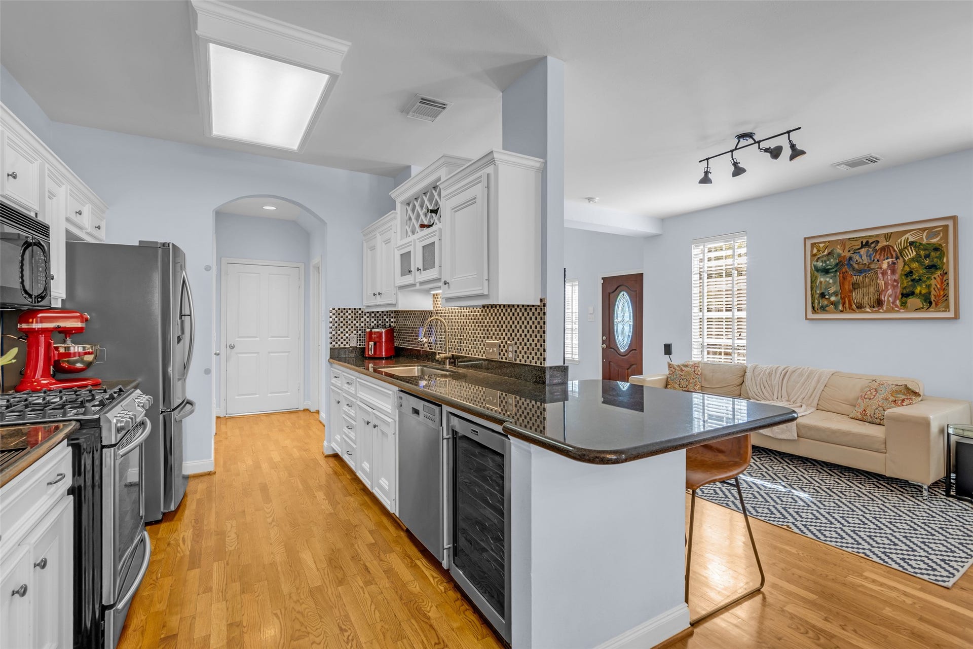 601 Lester Street, Houston, TX 77007 Stainless steel appliances in the kitchen, including a wine fridge. The refigerator is also included.
