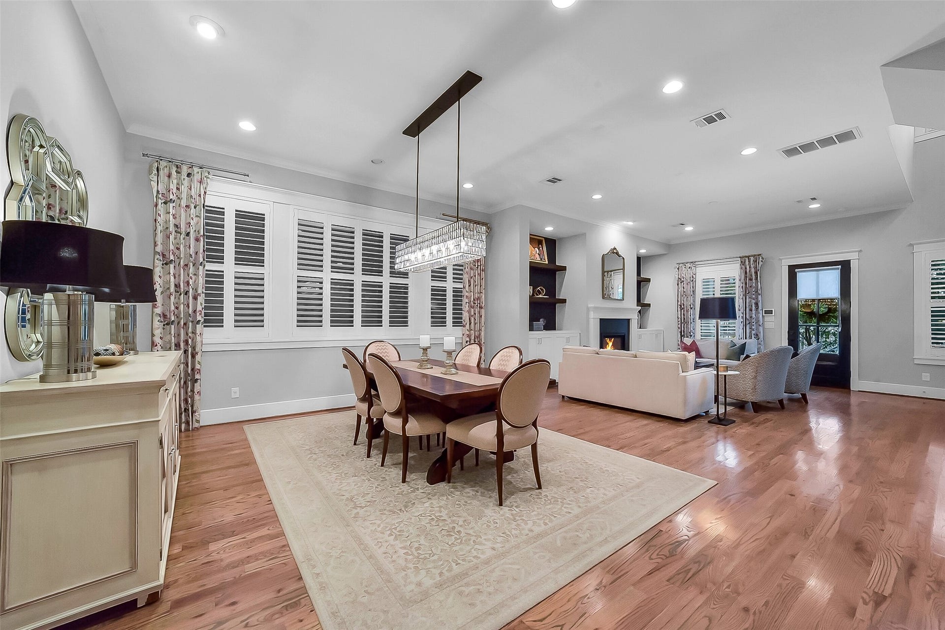 Another view of the dining room enhanced by large windows with plantation shutters. Spacious proportions easily accommodate both intimate dinners and larger gatherings. Open concept design makes this the ideal space for entertaiing and a very usable/funcctional space.