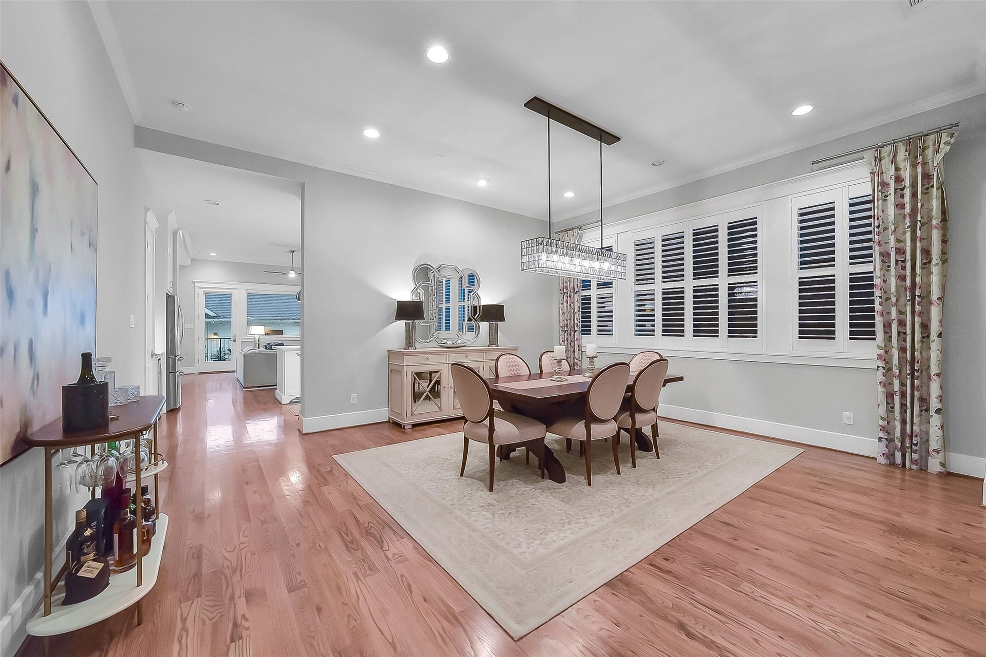 Formal dining room conveniently located between the living room and kitchen, creating excellent flow for entertaining. Features a striking crystal pendant chandelier, generous wall space for artwork and furnishings, and seamless connection to the surrounding living spaces.