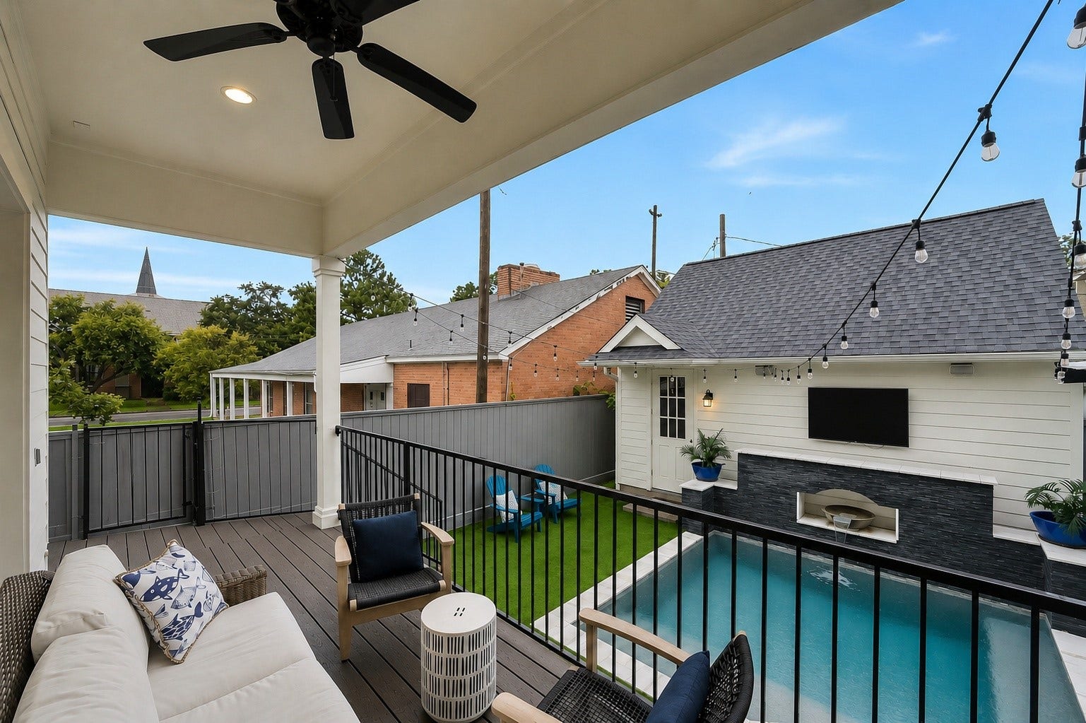 Covered back porch overlooking the pool and backyard, featuring recessed lighting, ceiling fan, and direct access from the family room. An inviting outdoor living space ideal for relaxing and grilling out! Ample space for outdoor dining and lounging. Landlord maintains yard and pool.