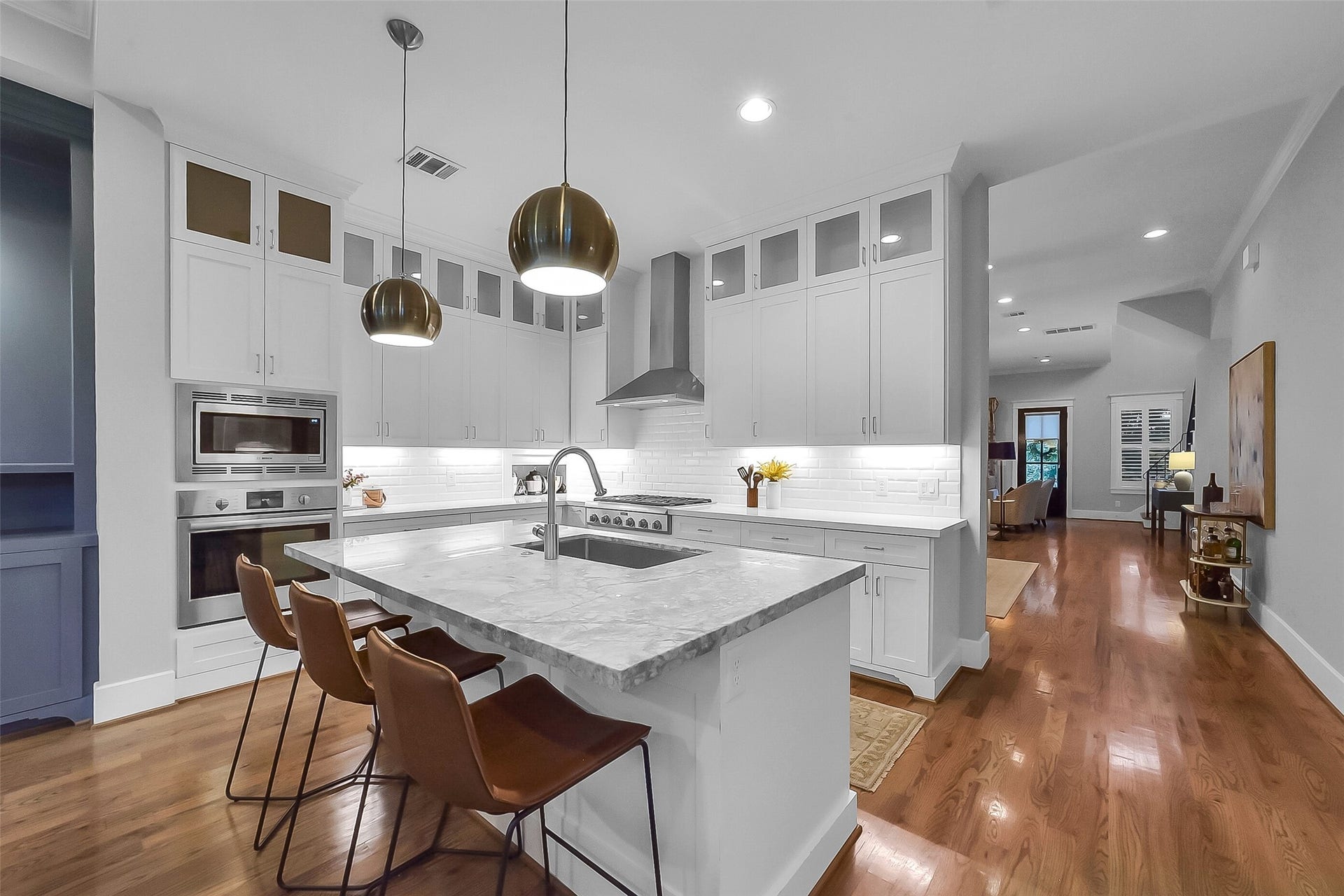 Second floor primary suite situated towards rear of the home, offering privacy. Spacious size offers flexibility for a variety of furniture arrangements. Features hardwood flooring, tray ceiling with crown molding, recessed lighting, ceiling fan, and three large windows with plantation shutters.