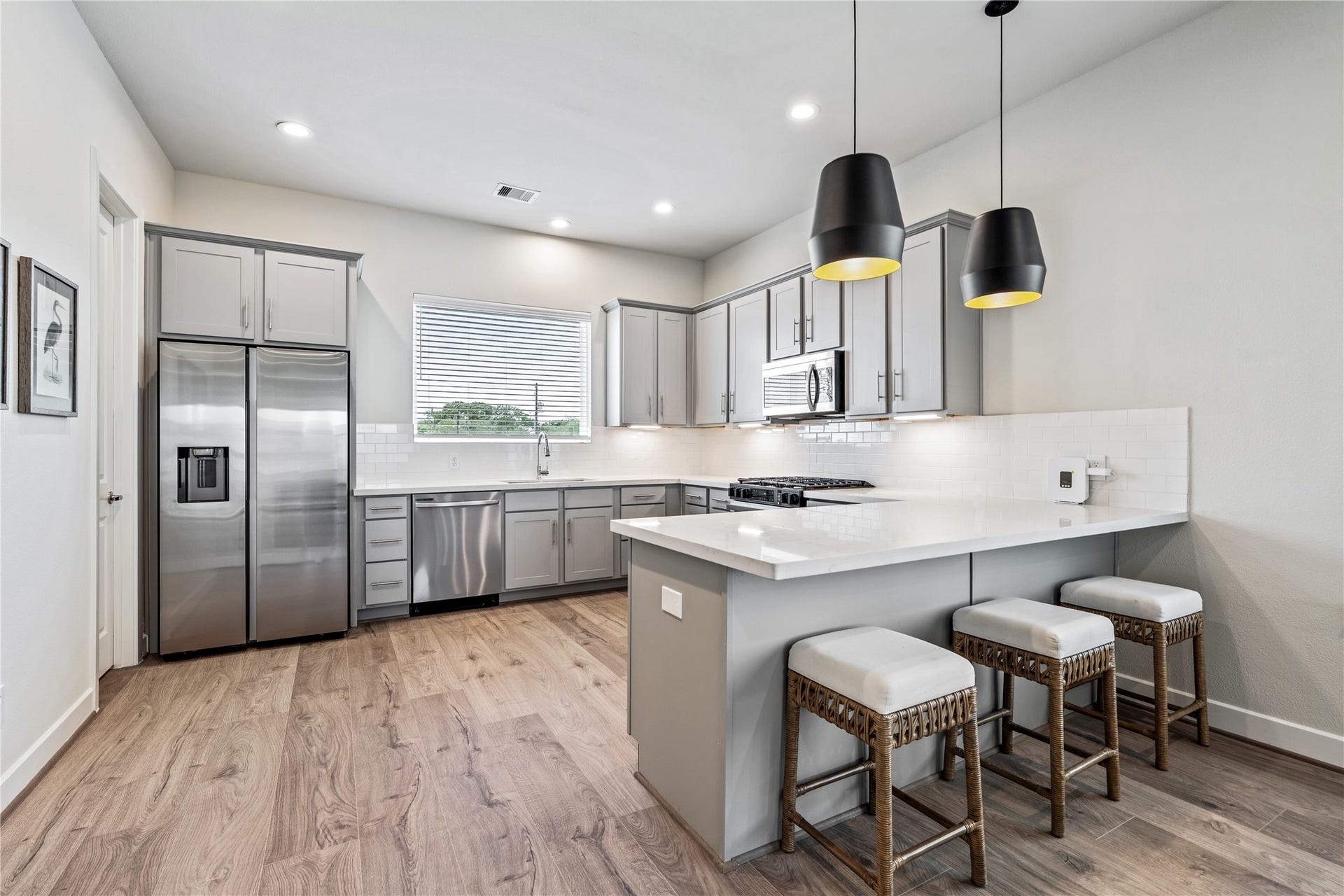 3916 Willowbend Point Drive, Houston, TX 77025 Representative photo showing the communitys model home kitchen. Layout and selections may vary.
